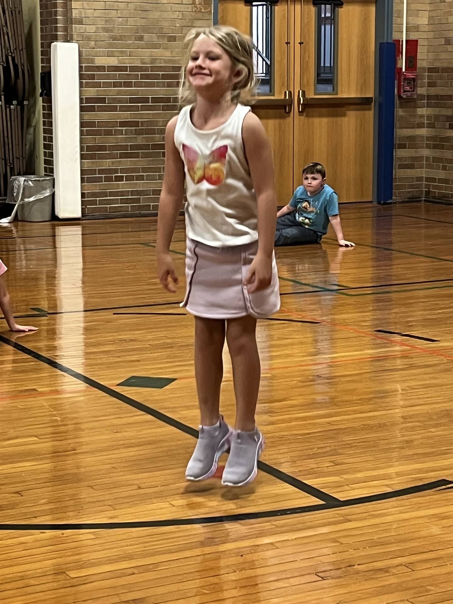 student in the gym jumping
