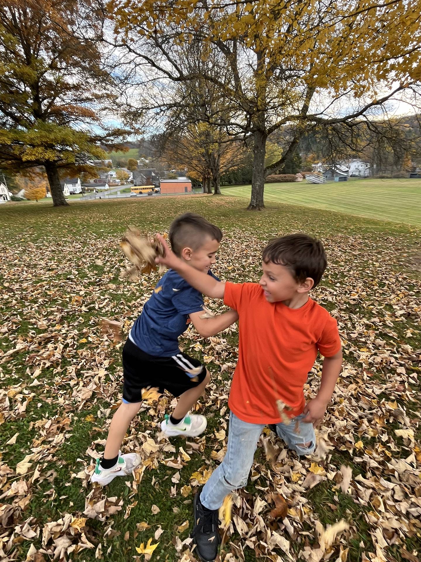 2 students throwing leaves