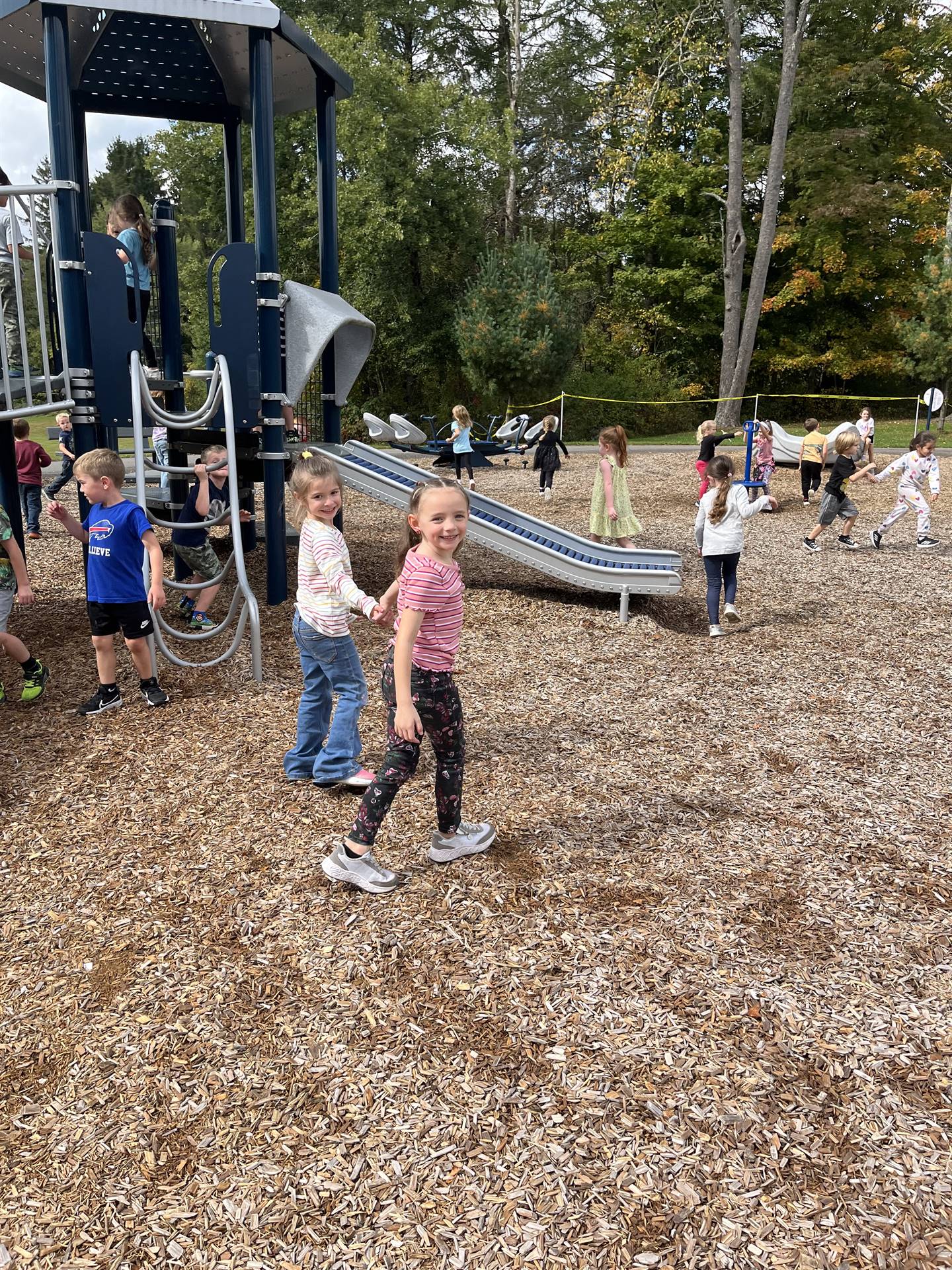 students holding hands on playground