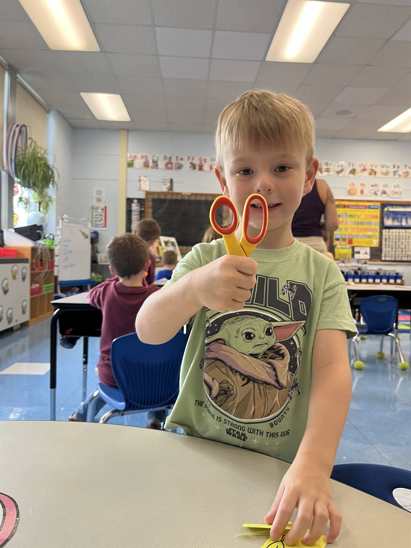 student holding scissors safely by the point end.