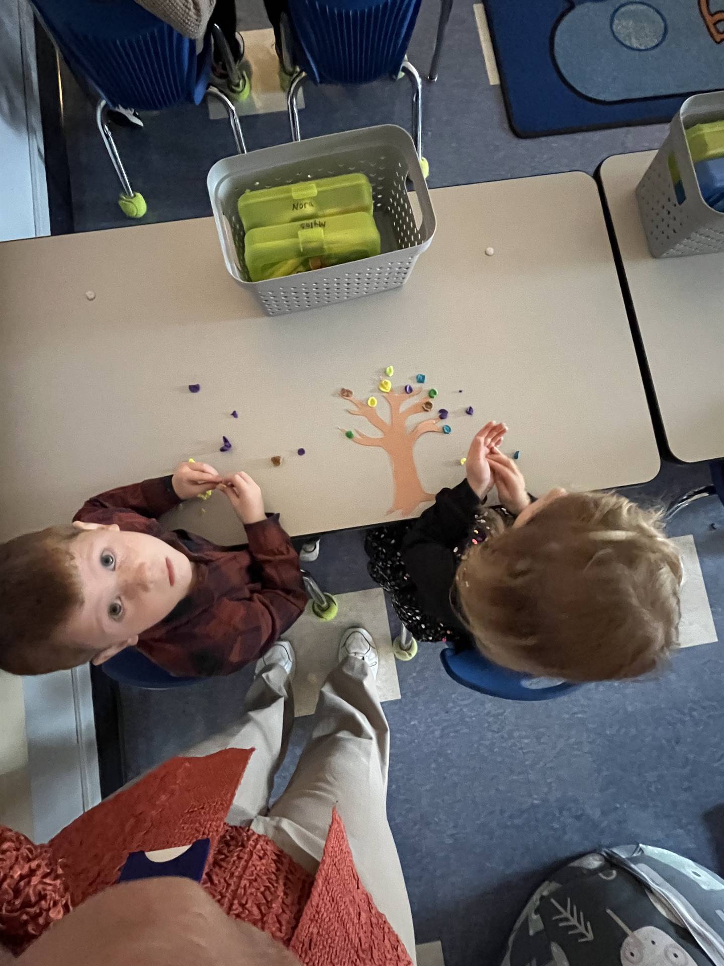 2 students using play do to create leaves for a bare fall tree