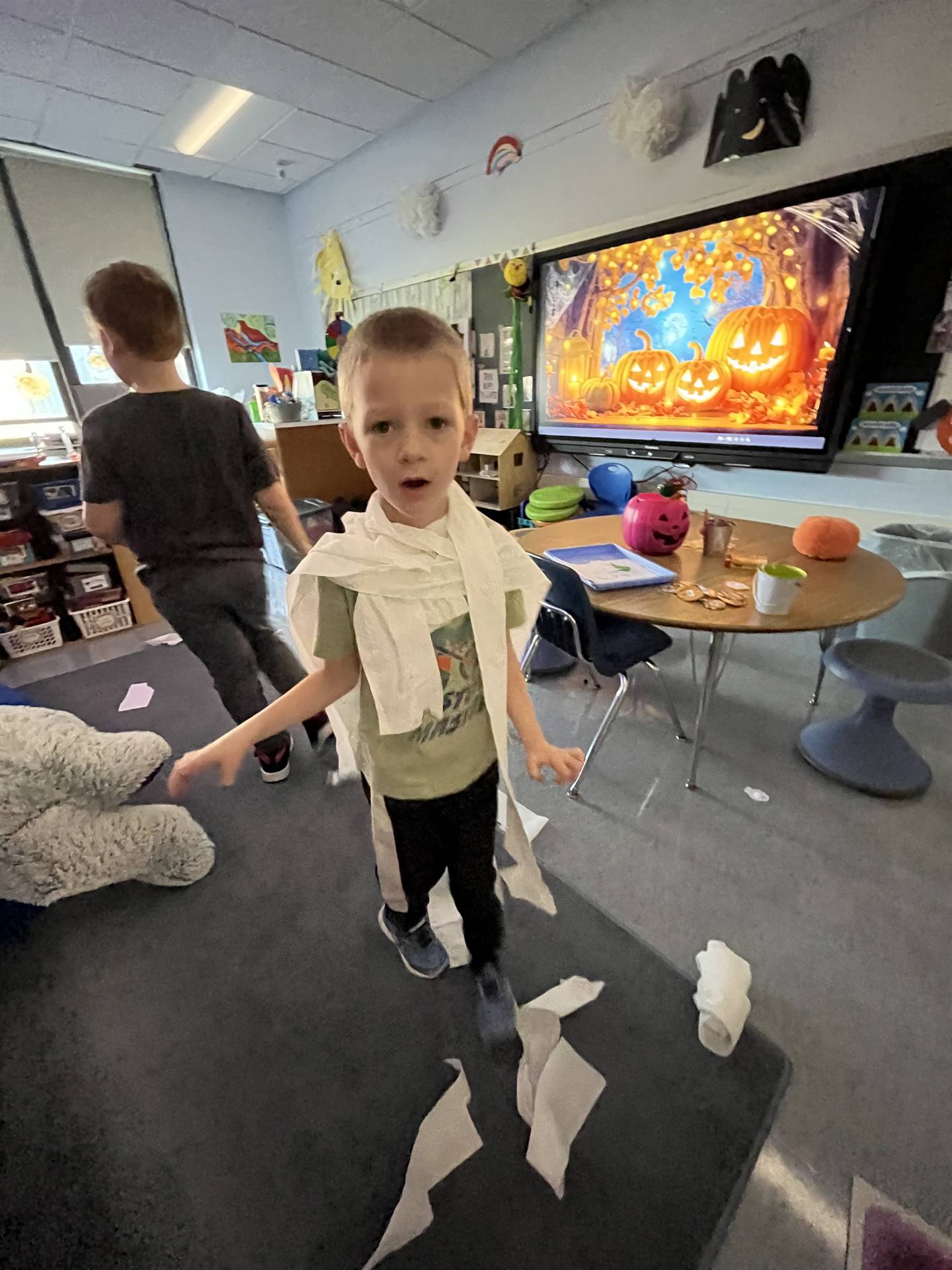kid wrapped in toilet paper like a mummy