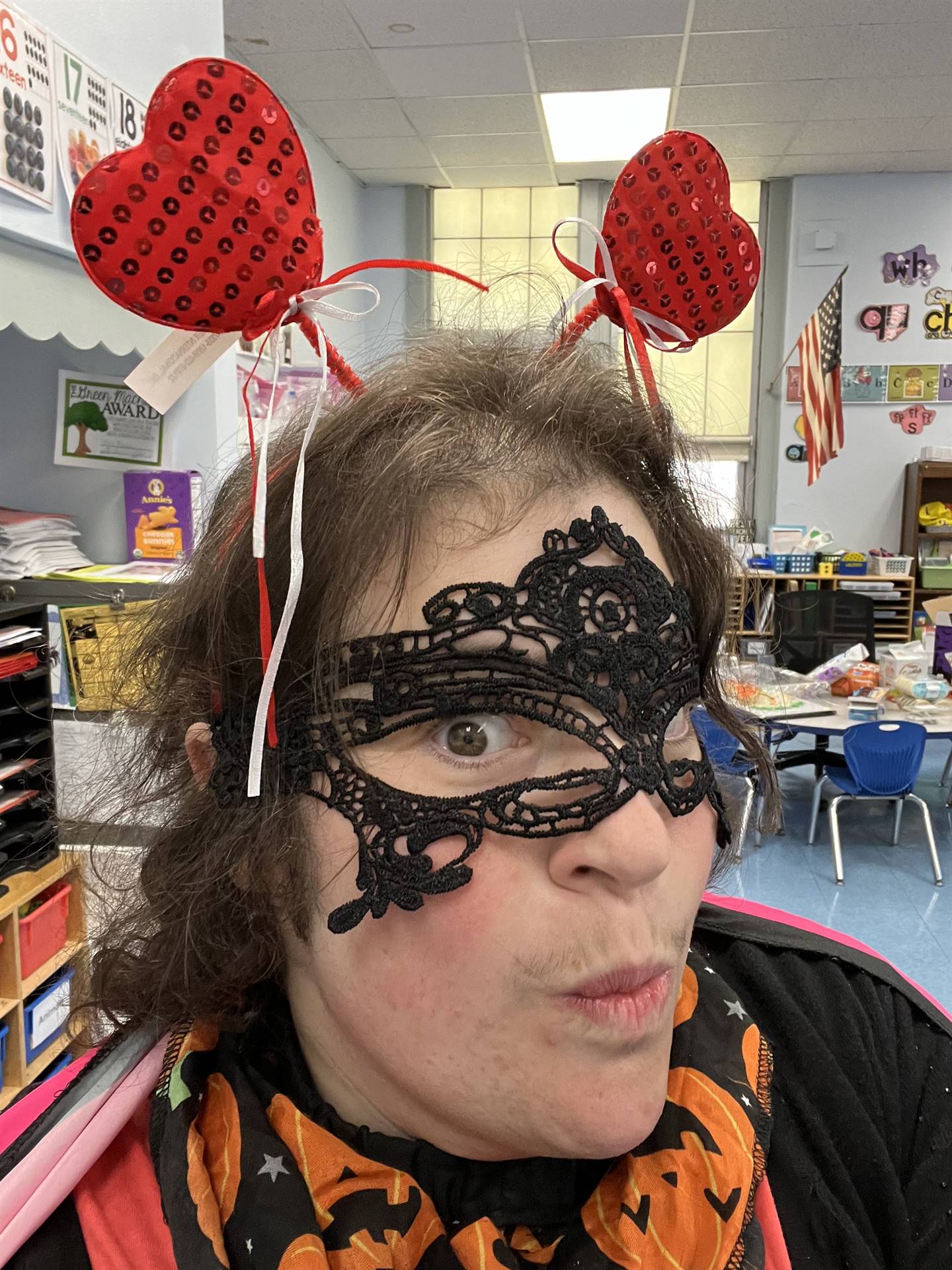 an adult selfie with a black mask and heart antennae