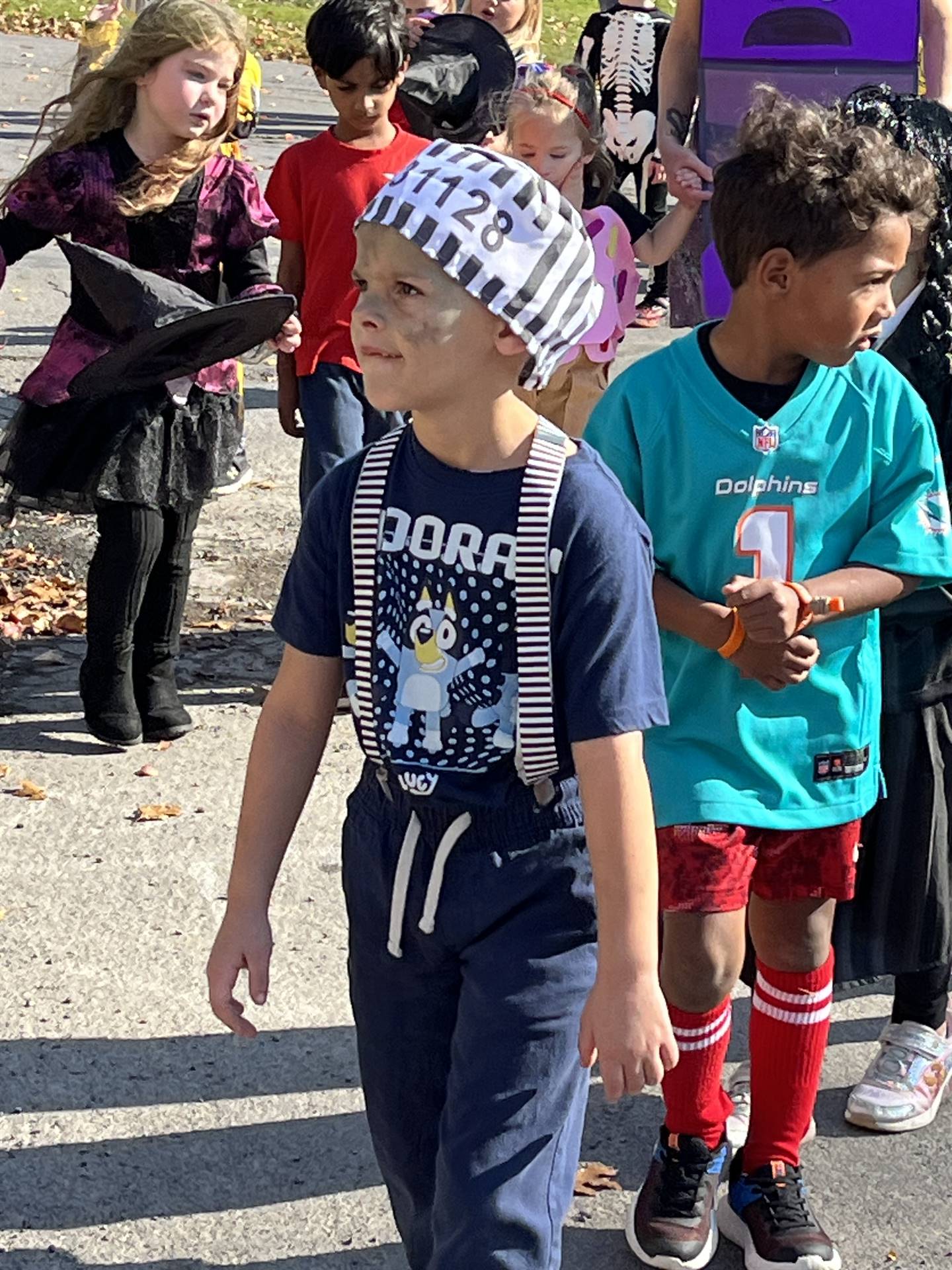 students marching in halloween parade outdoors!