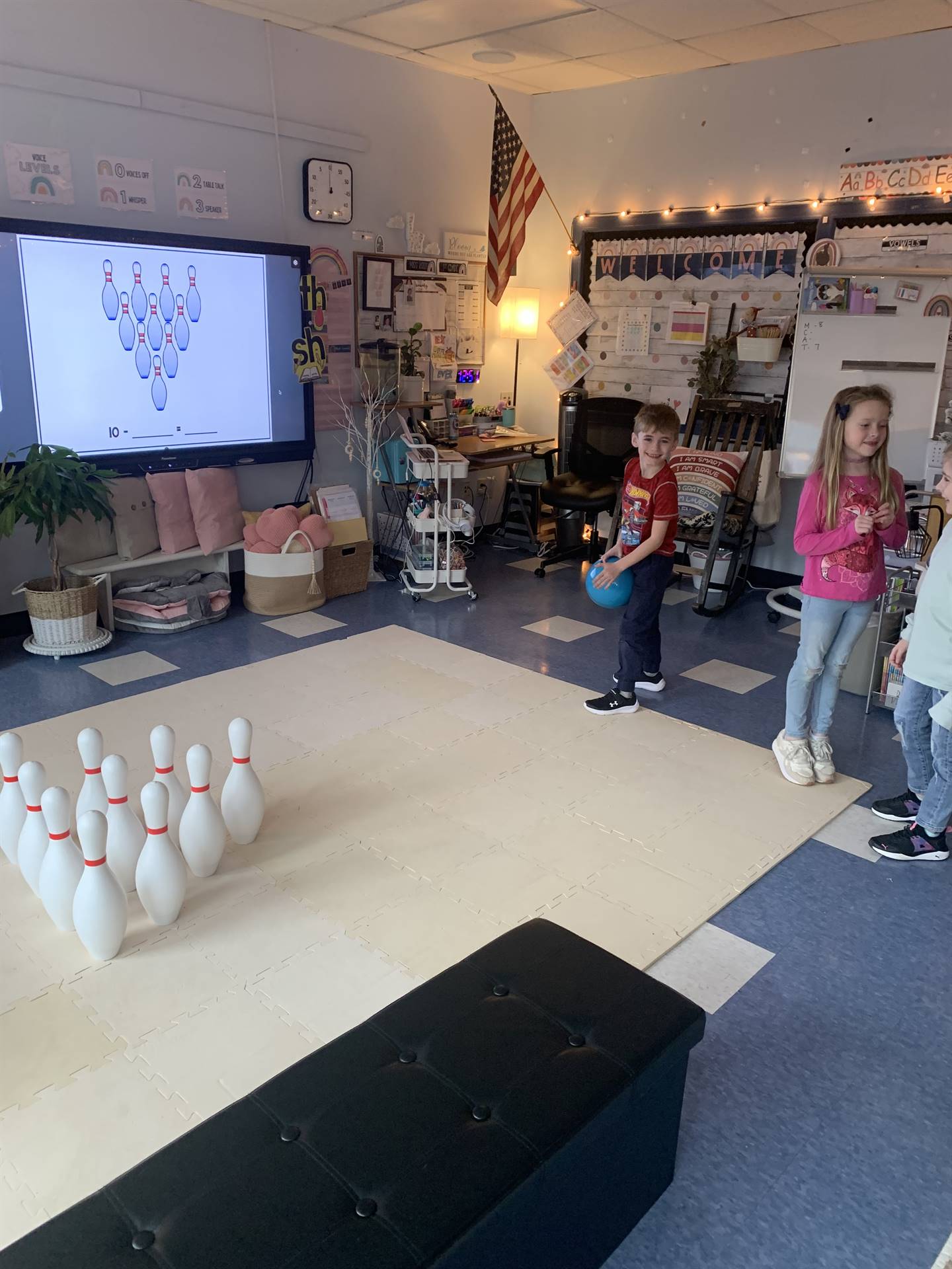 a student throws a bowling ball at the pins.