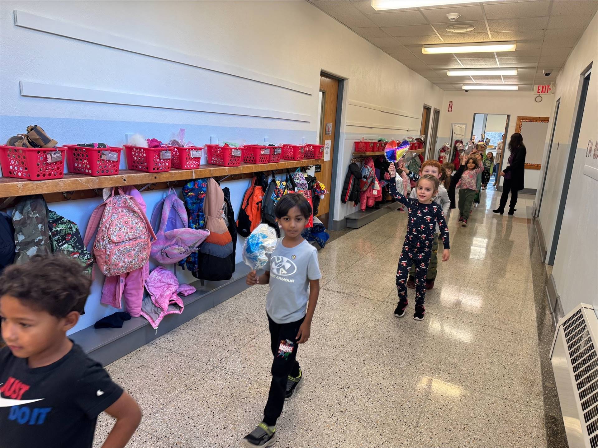 children walking in hallway reenacting a Macy's Day parade complete with balloons!
