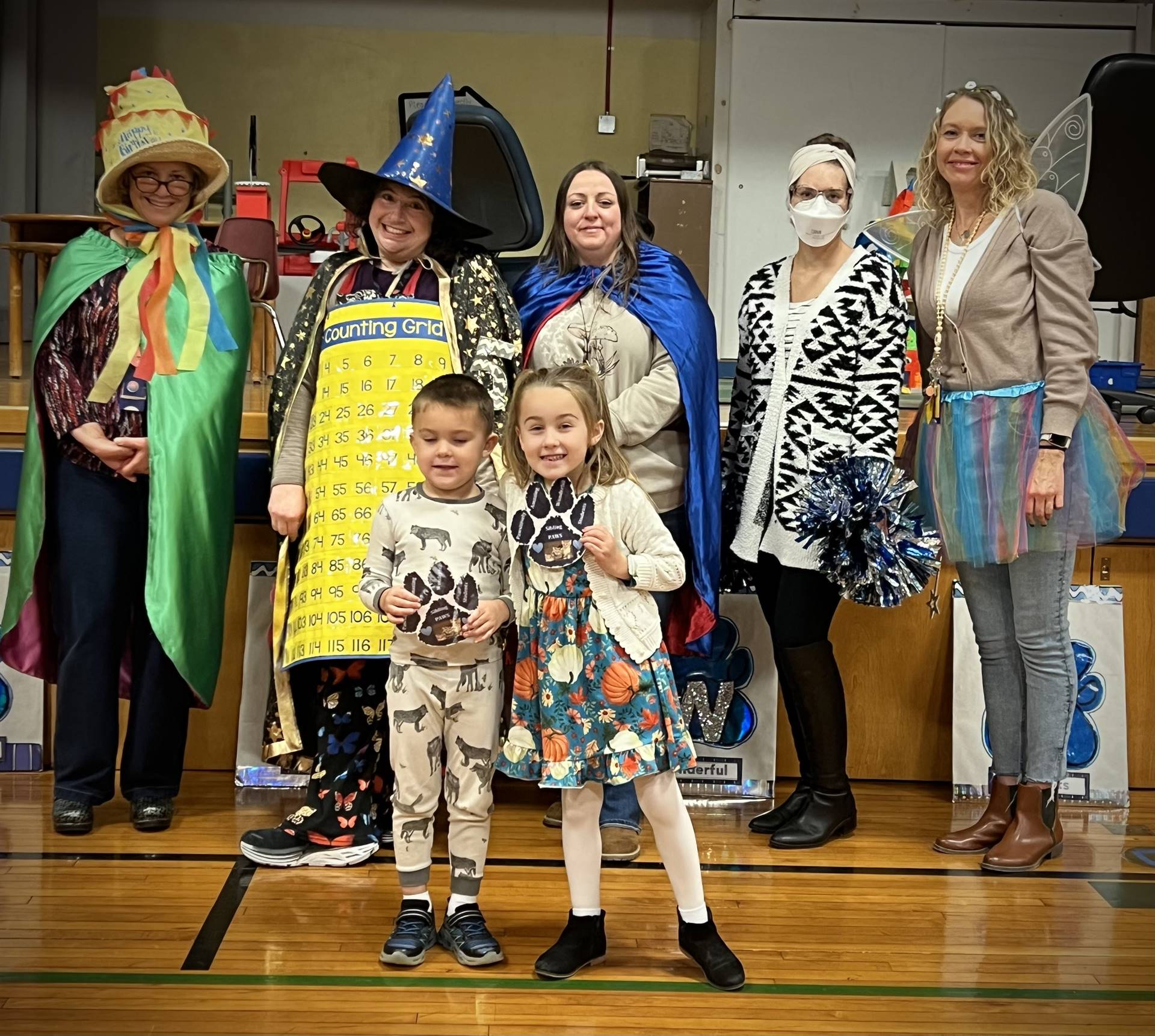 adults dressed as characters with 2 kids in front