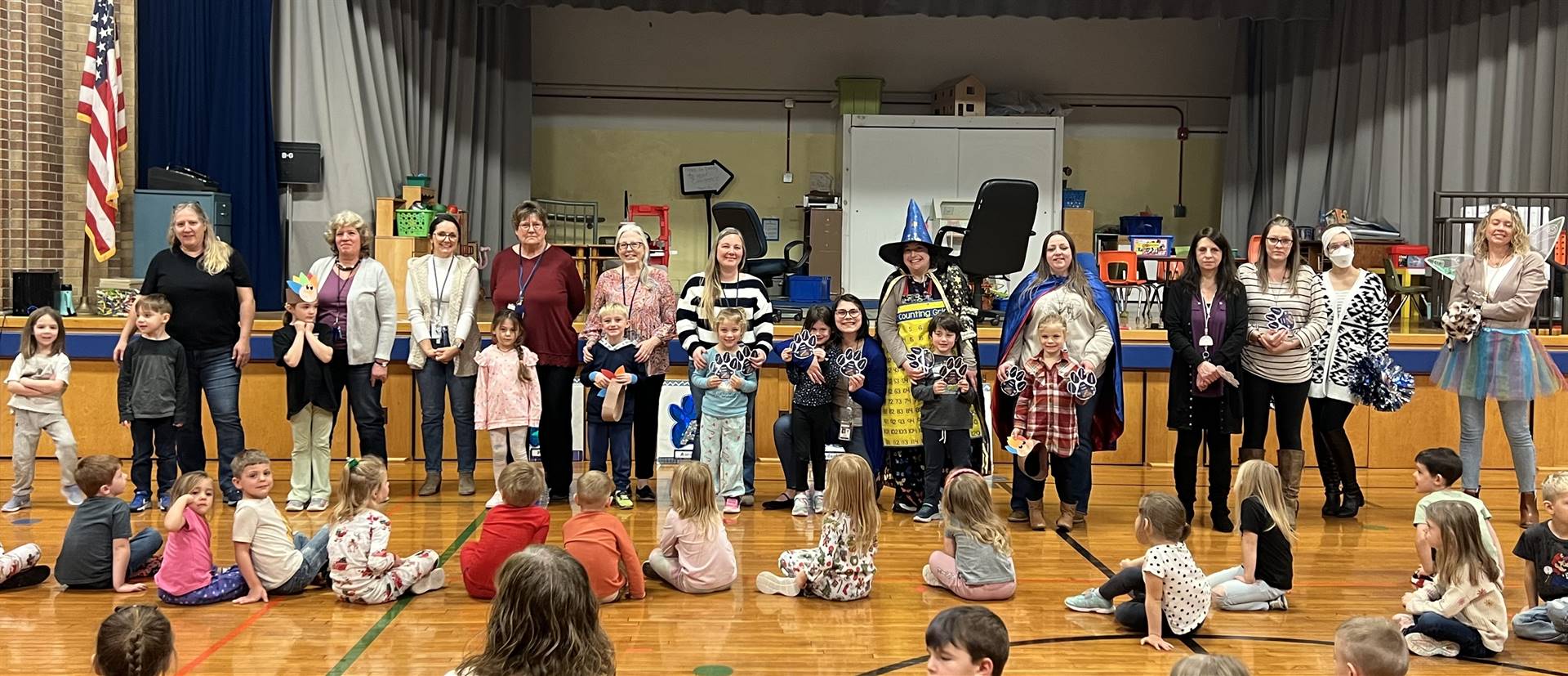 A group of adults and kids at an assembly