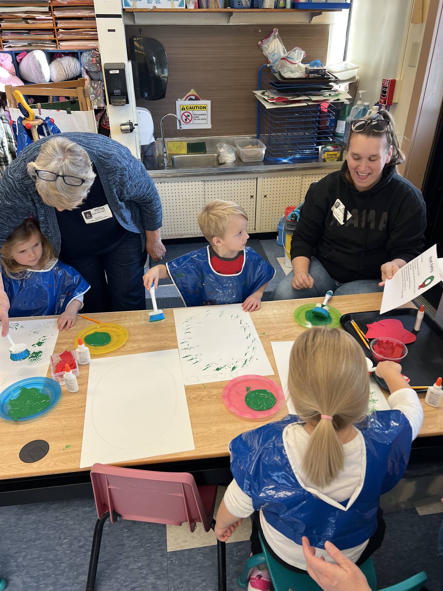 adults and students crafting together