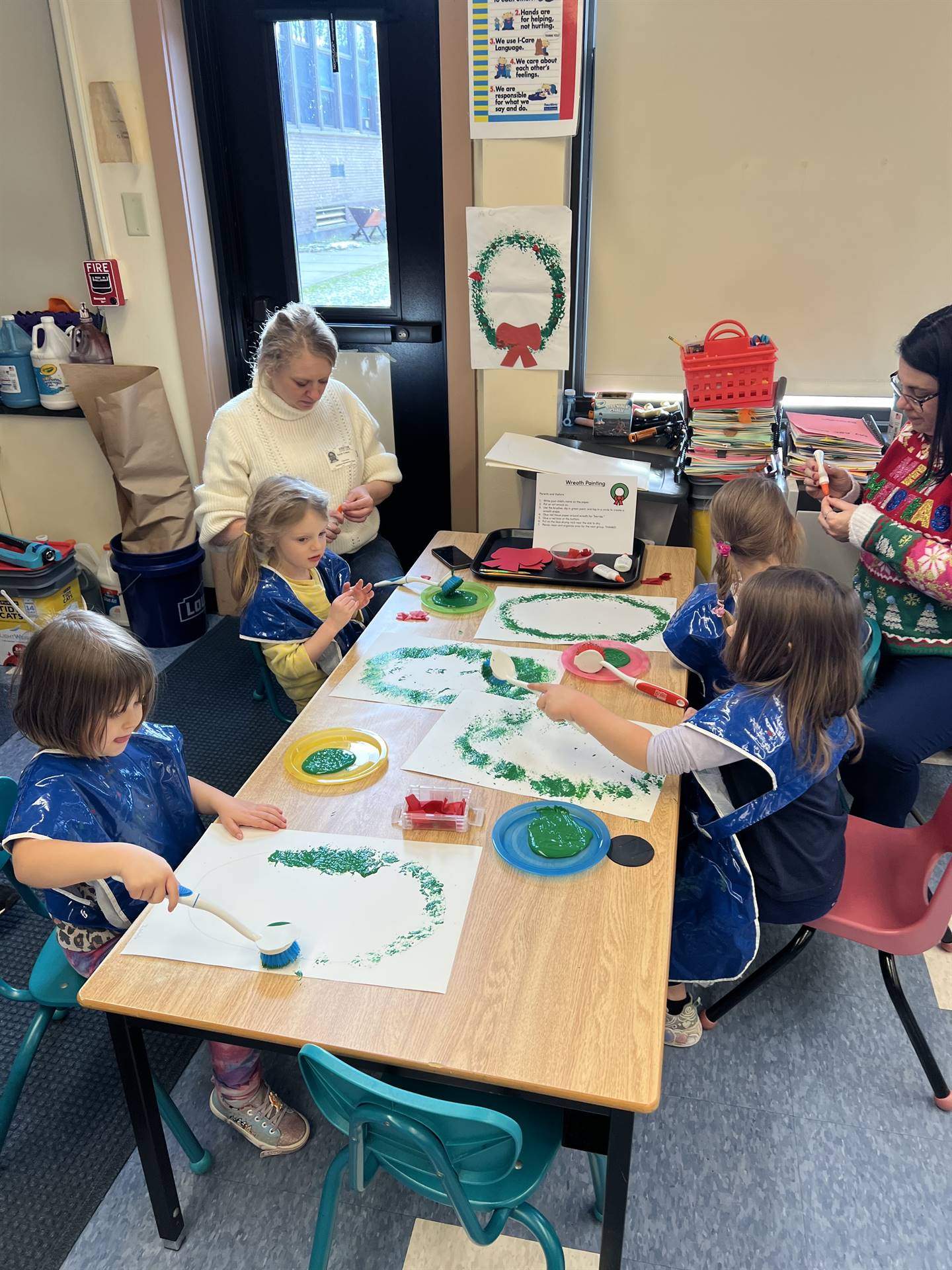 adults and students painting together