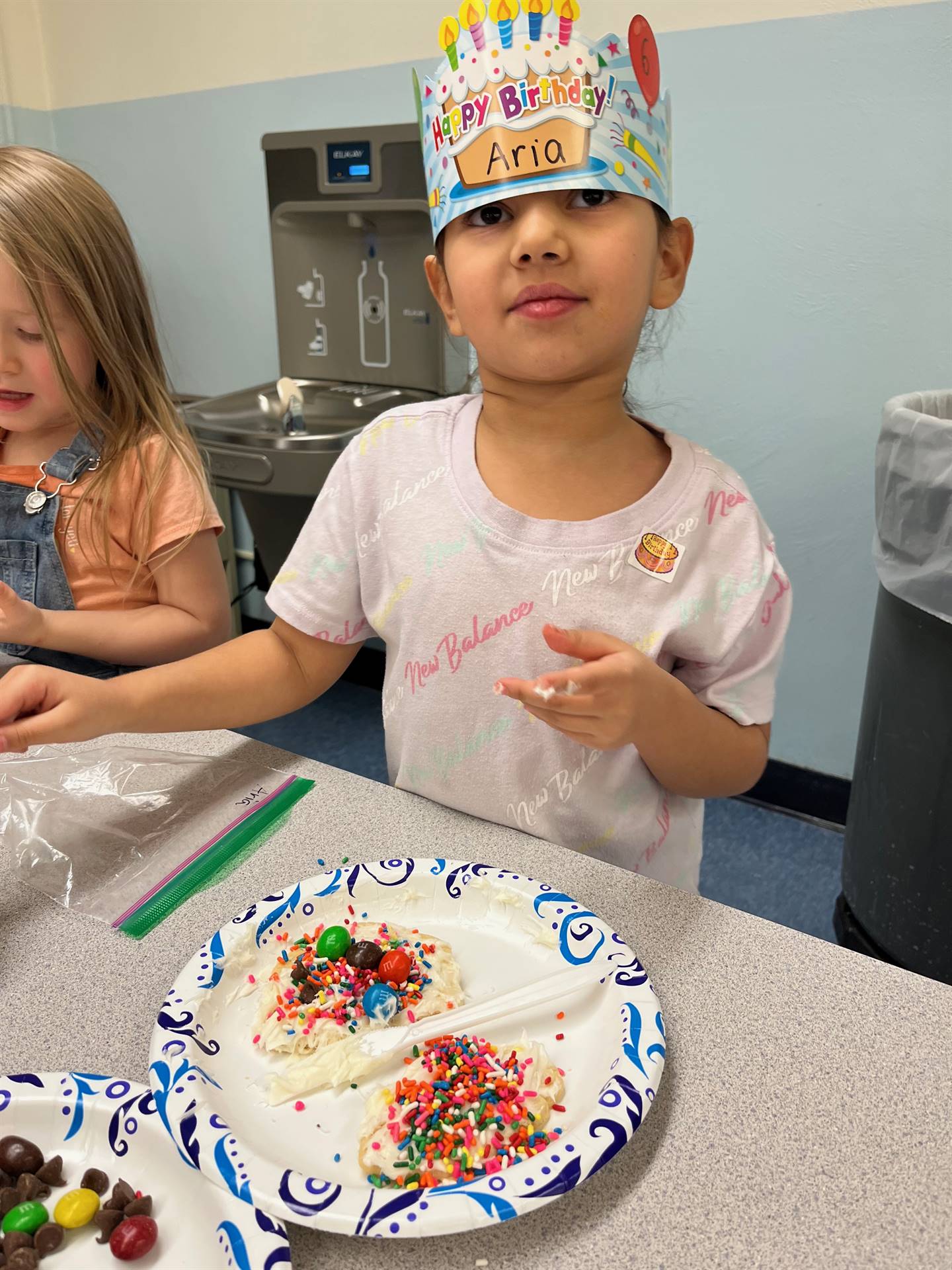 student decorating sugar cookie with icing and candy