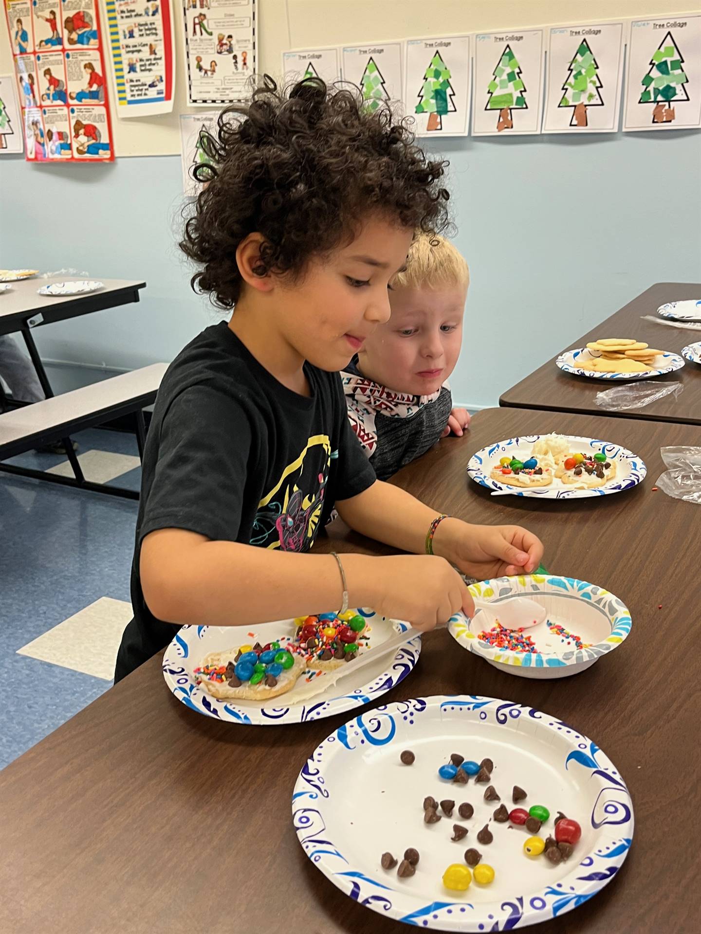 student decorating sugar cookie with icing and candy