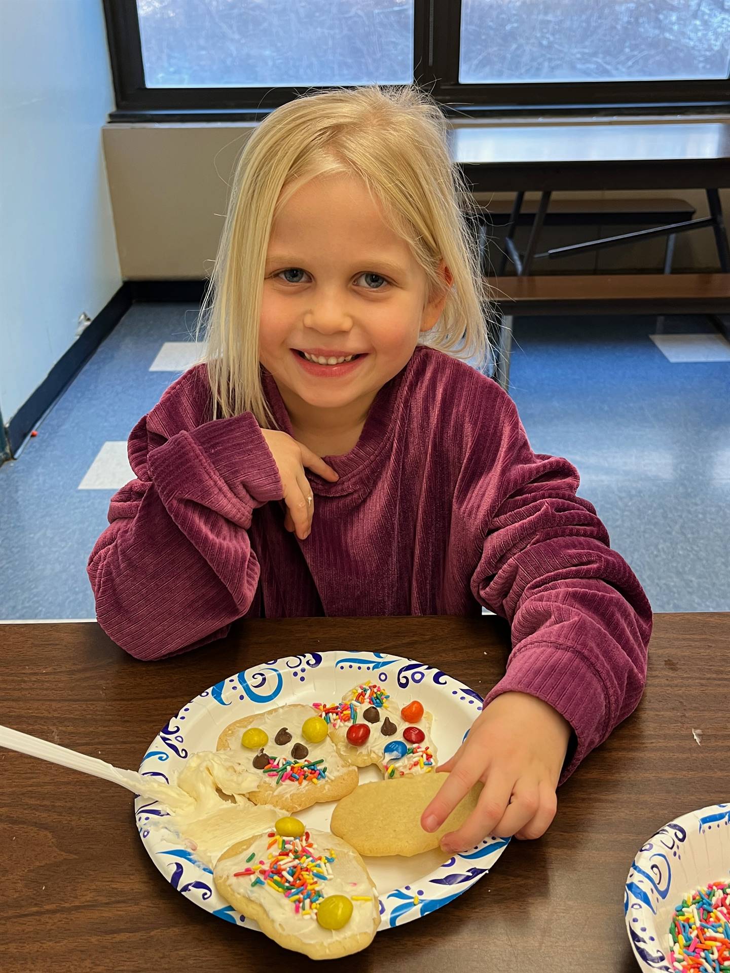 student done decorating sugar cookies with icing and candy