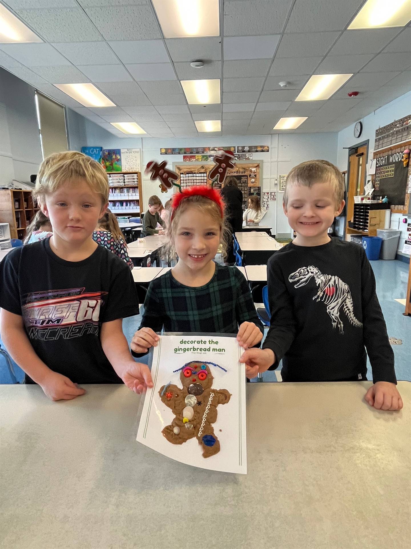 3 students worked together to create a play do ginger bread friend.