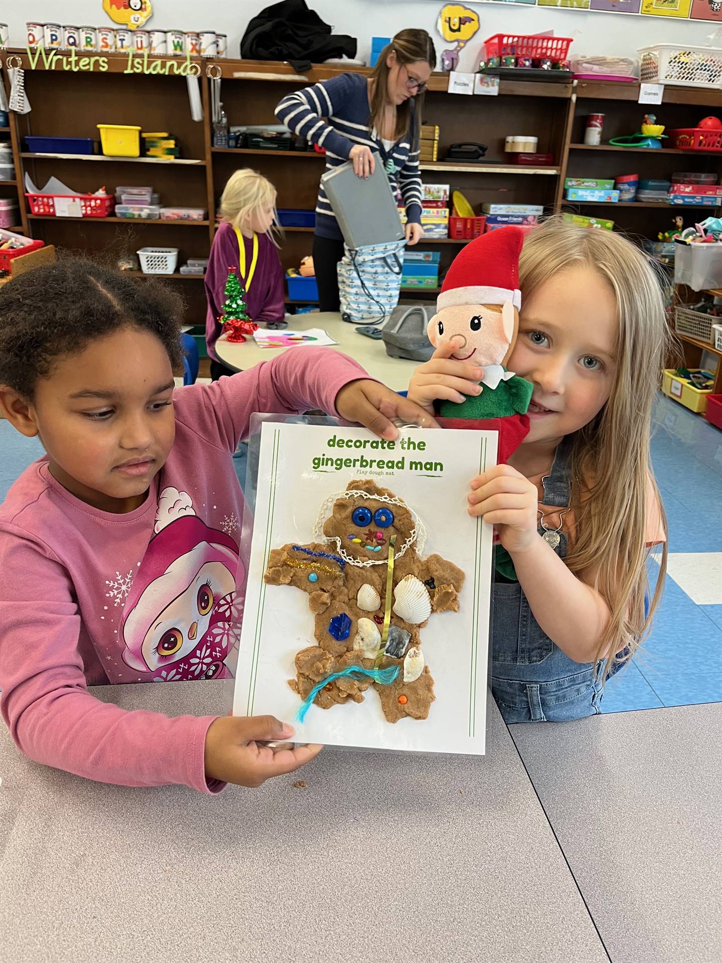 2 students plus an elf worked together to create a play do ginger bread friend. 