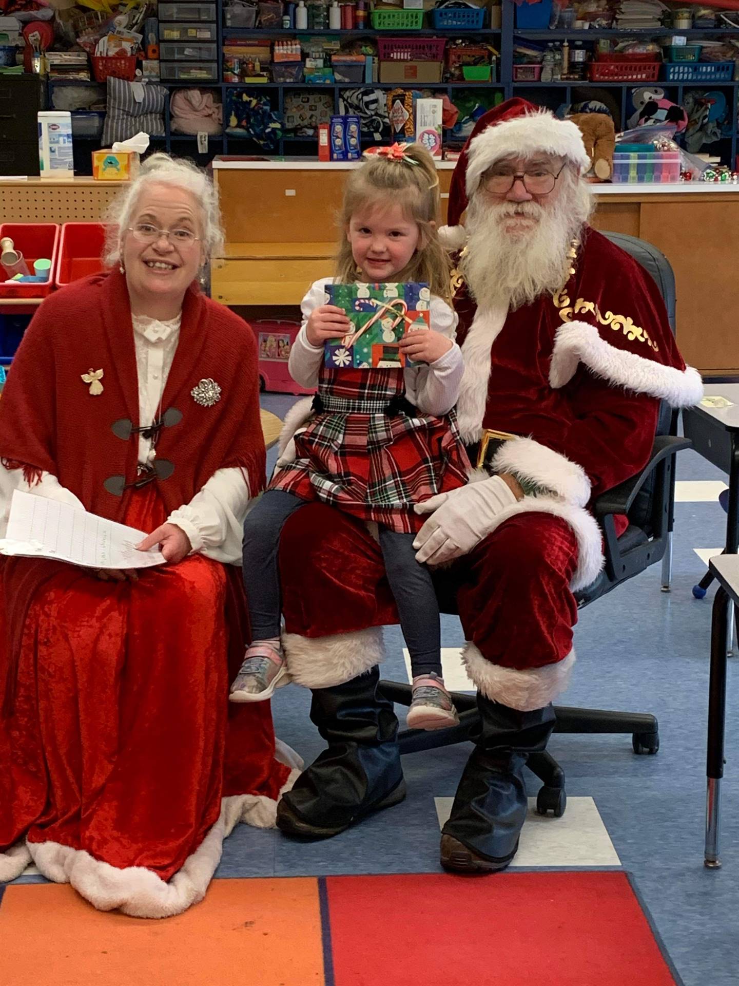 Santa and Mrs. Clause with student