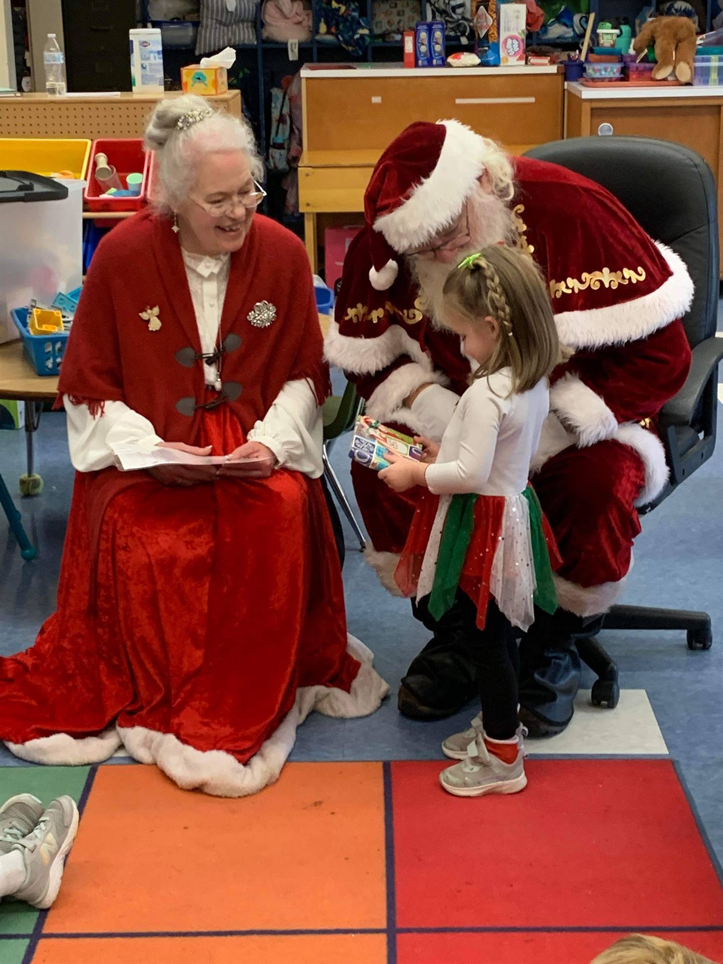 Santa and Mrs. Clause with student