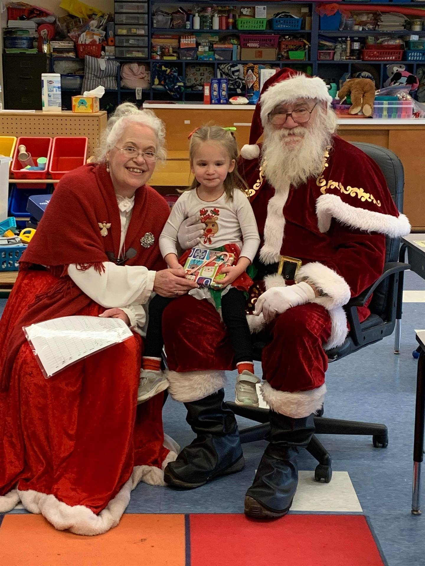 Santa and Mrs. Clause with student