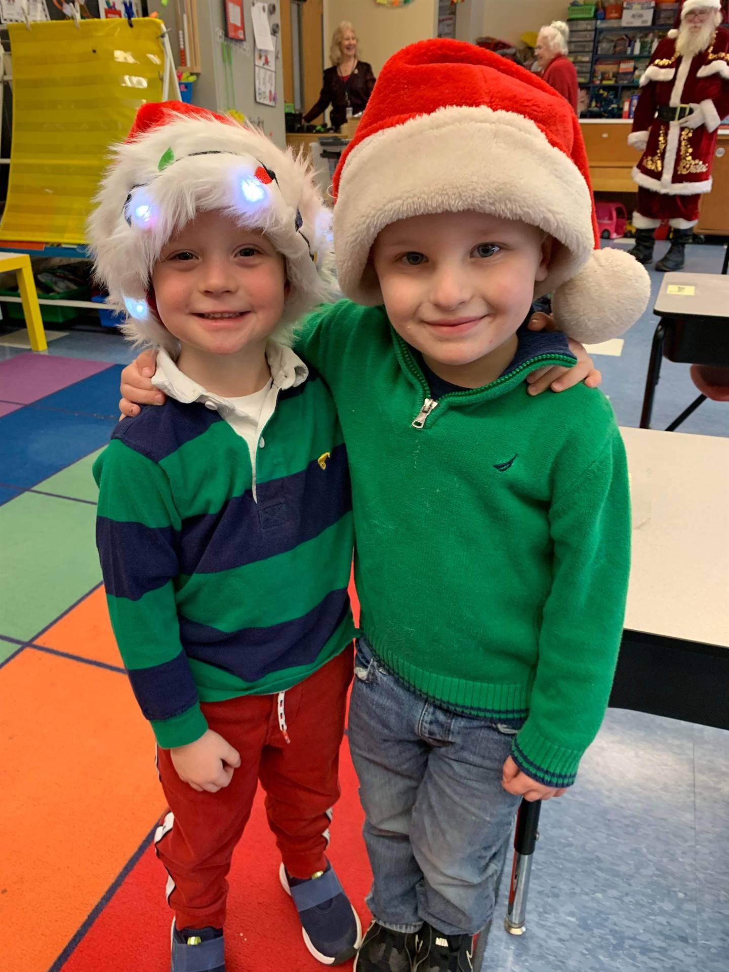 2 students with santa hats on.