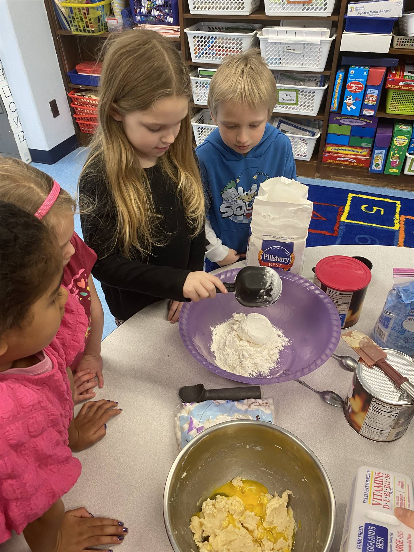 students mixing cookie ingredients. 