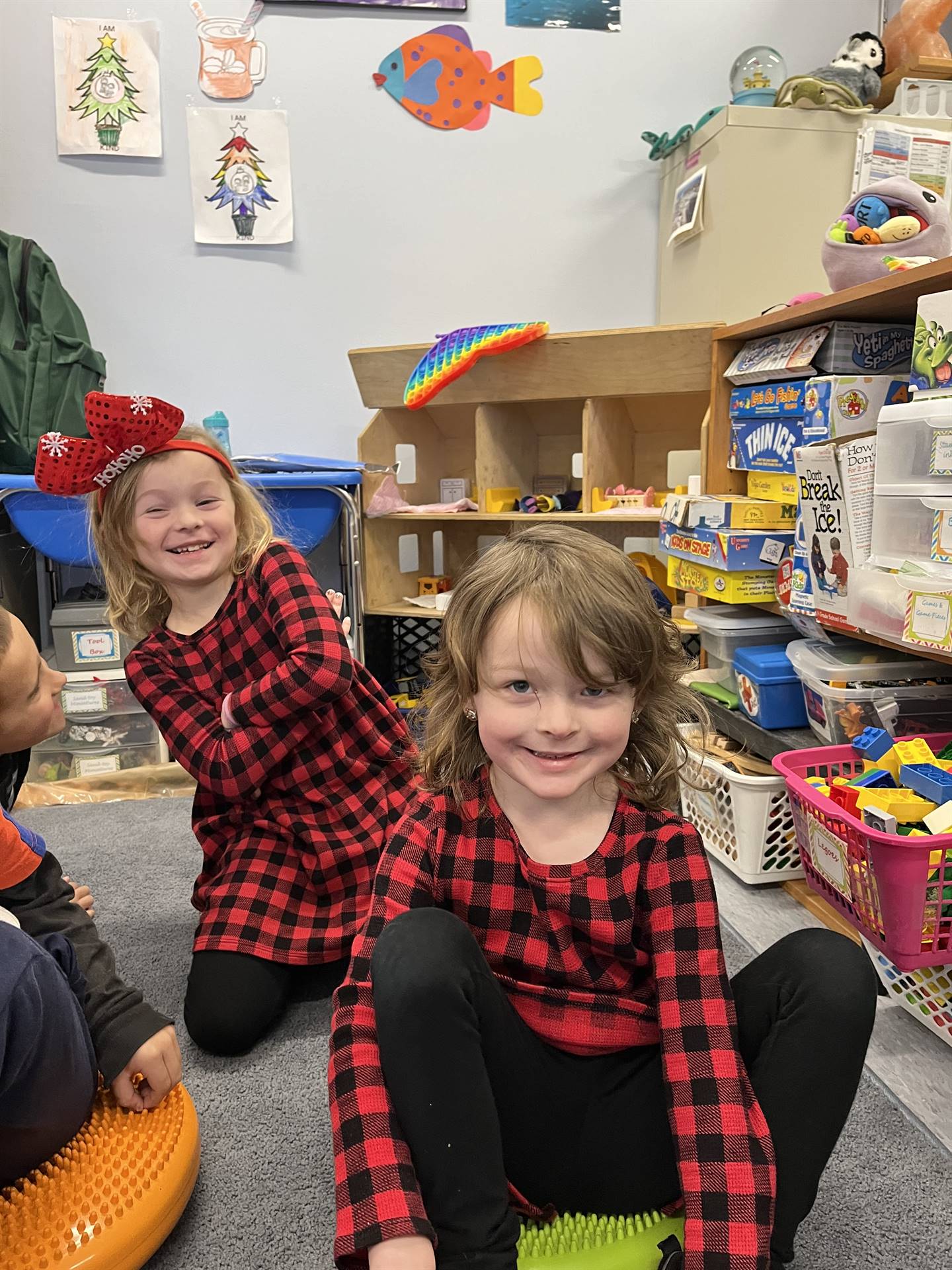 2 students in matching black and red plaid shirts