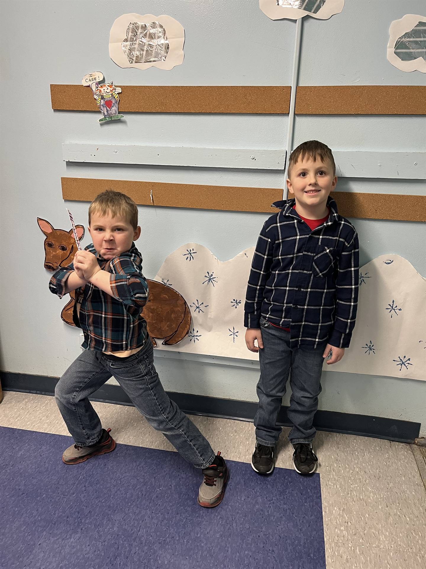 2 kids in matching black and blue plaid shirts