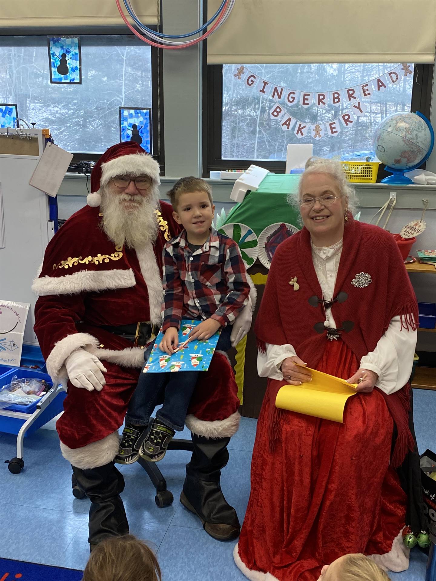 Santa and Mrs. Clause with student