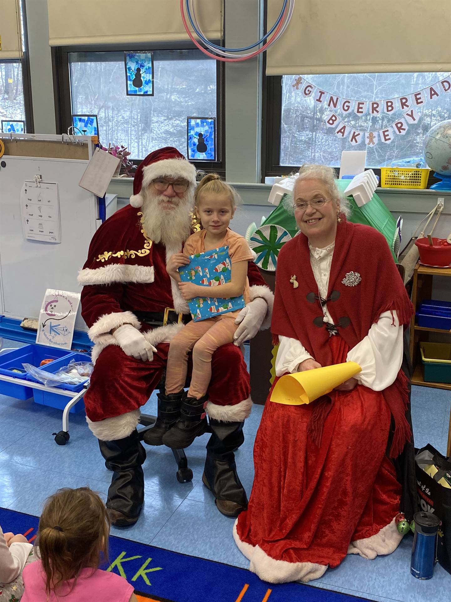 Santa and Mrs. Clause with student