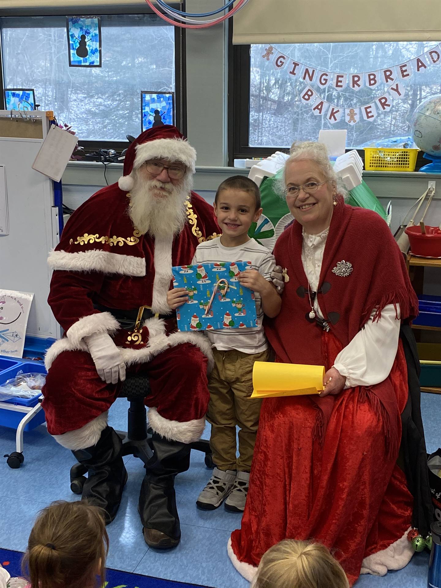 Santa and Mrs. Clause with student