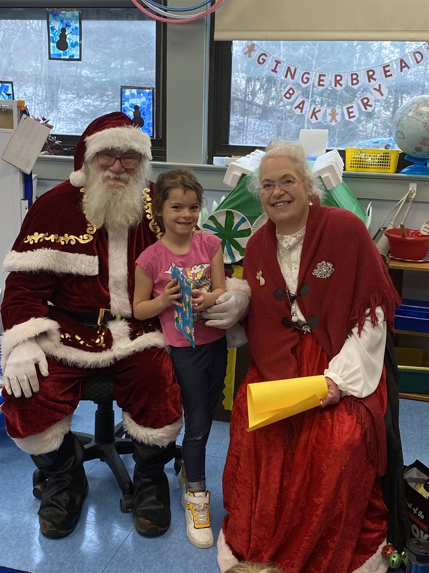 Santa and Mrs. Clause with student