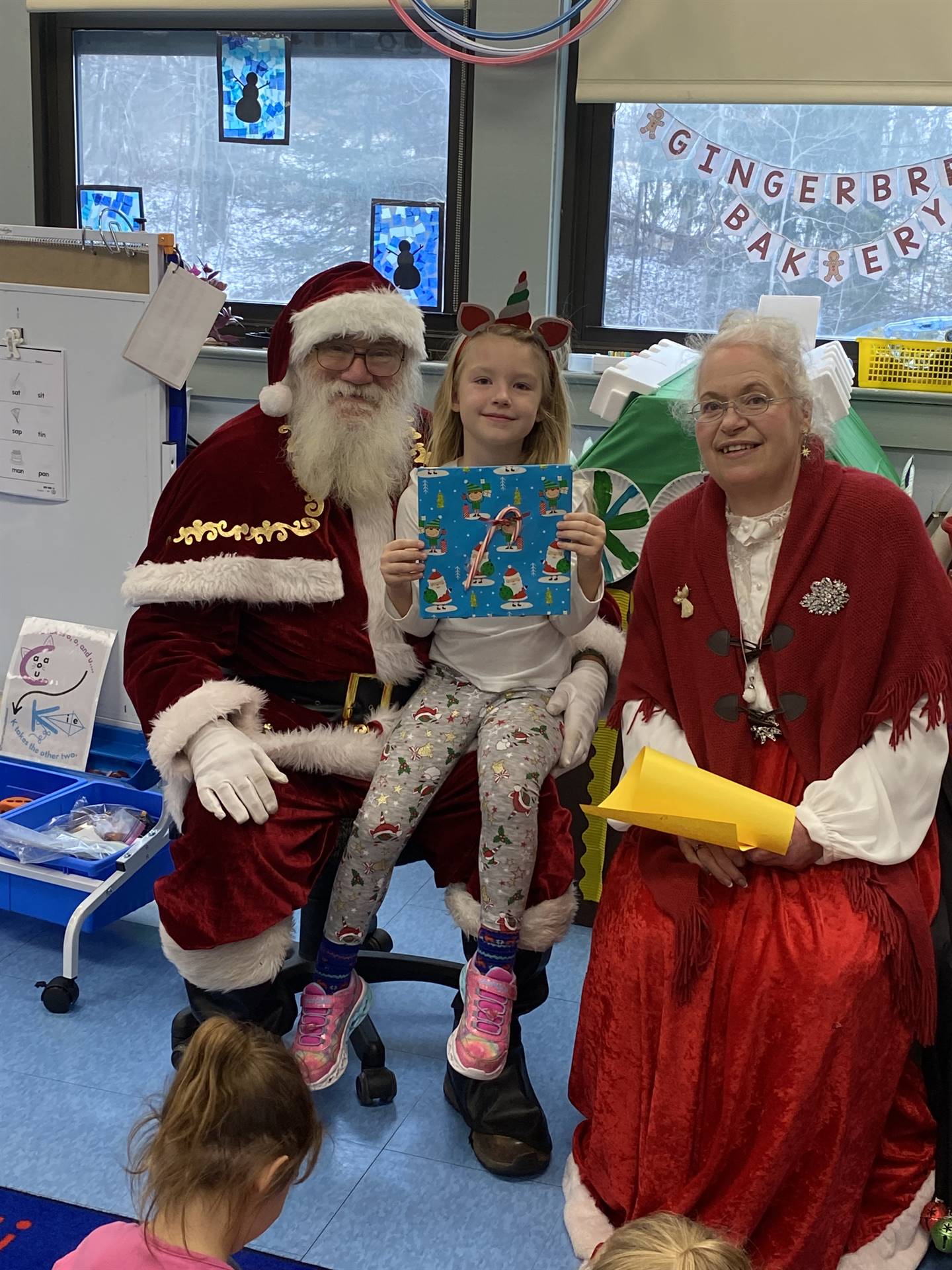 Santa and Mrs. Clause with student