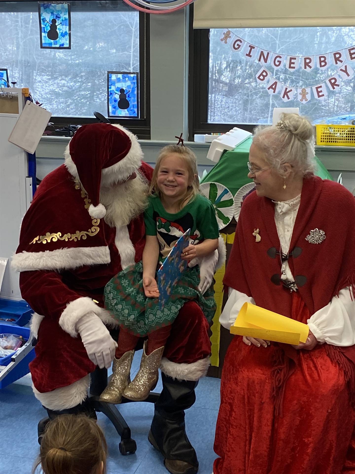 Santa and Mrs. Clause with student