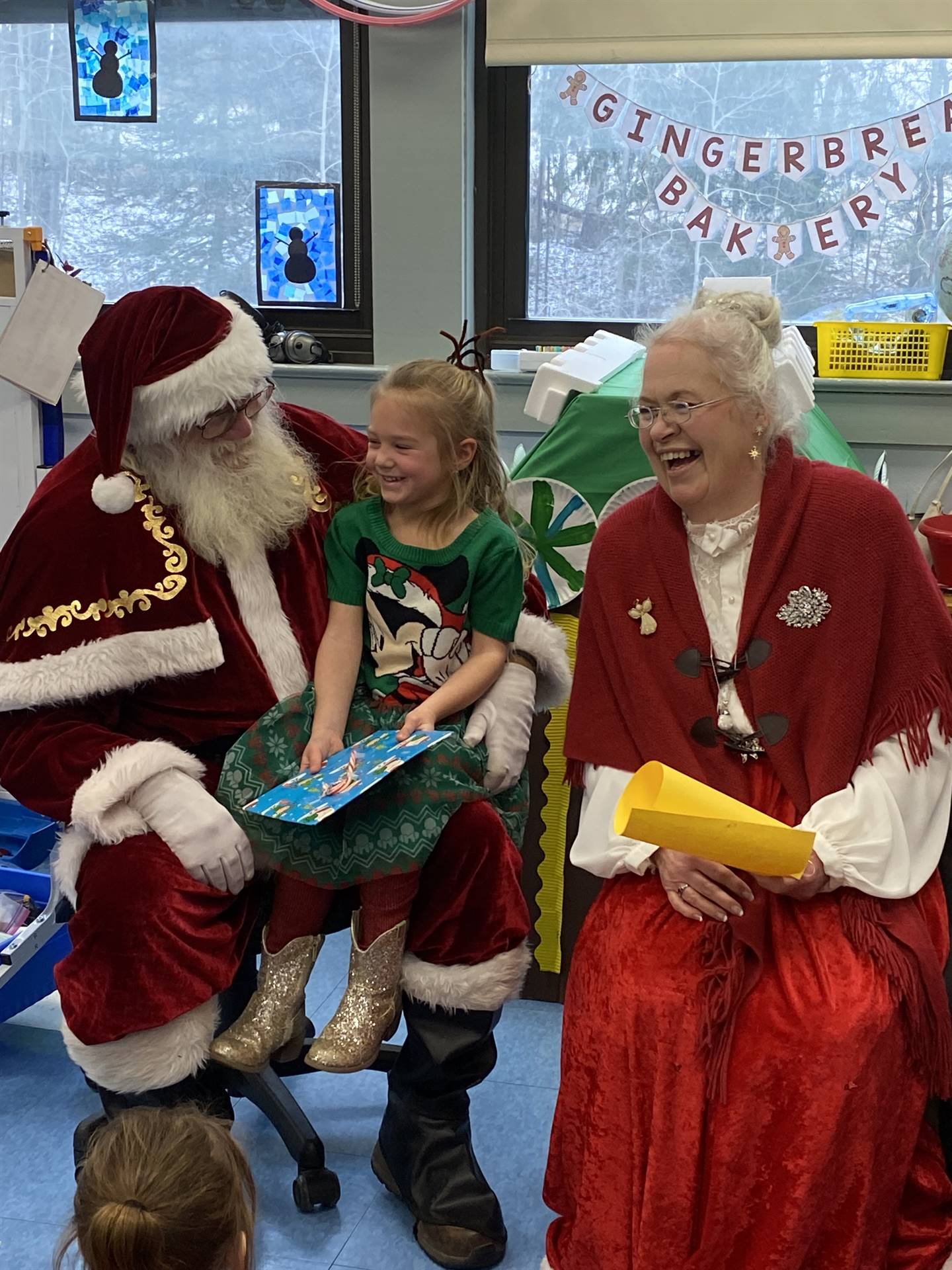 Santa and Mrs. Clause with student