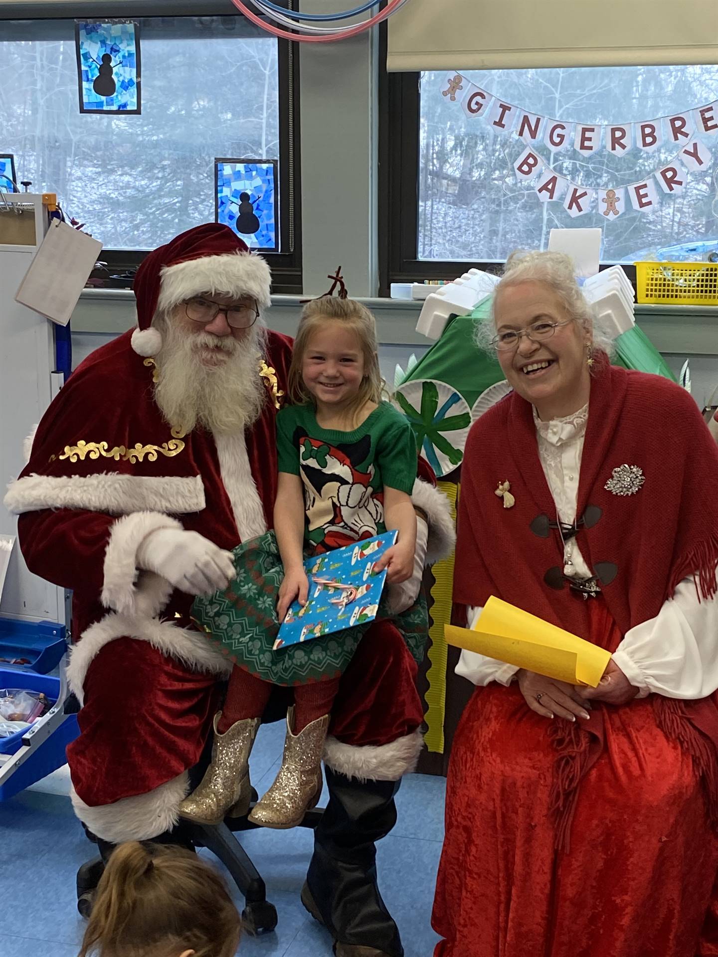 Santa and Mrs. Clause with student