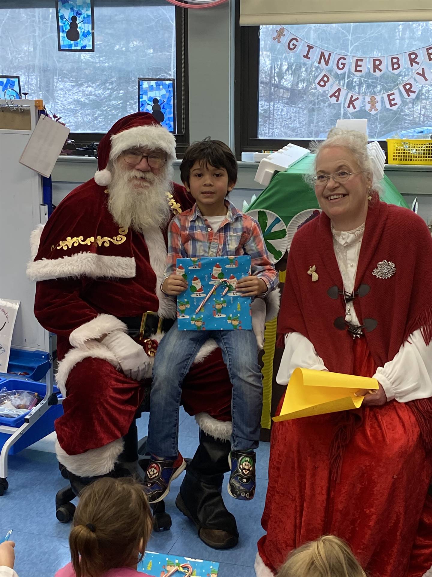 Santa and Mrs. Clause with student