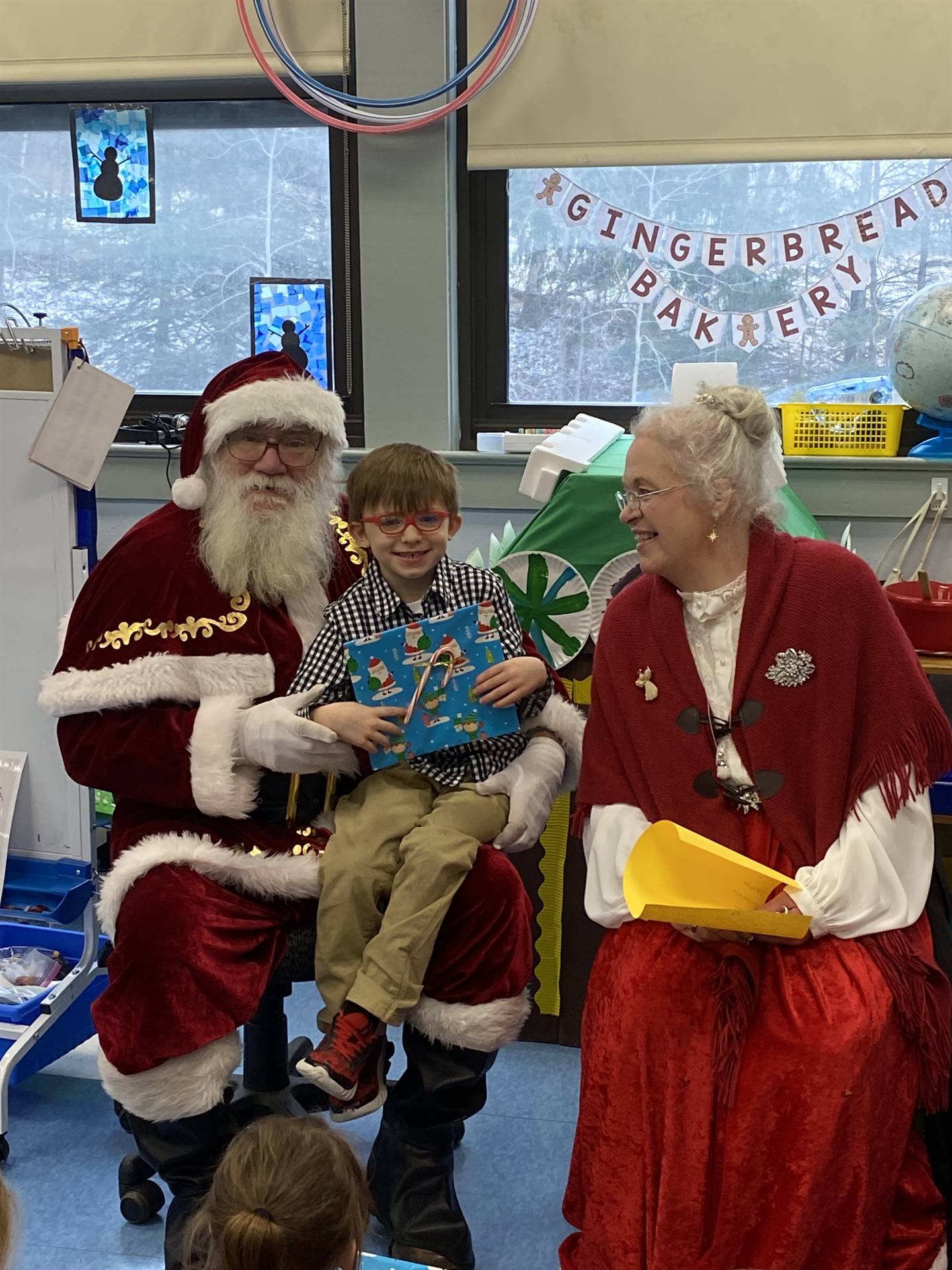 Santa and Mrs. Clause with student