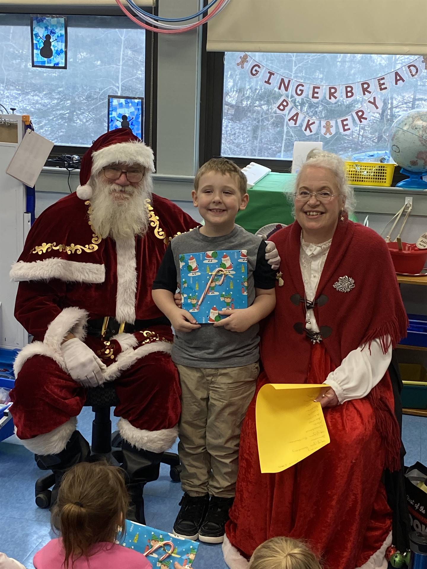 Santa and Mrs. Clause with student