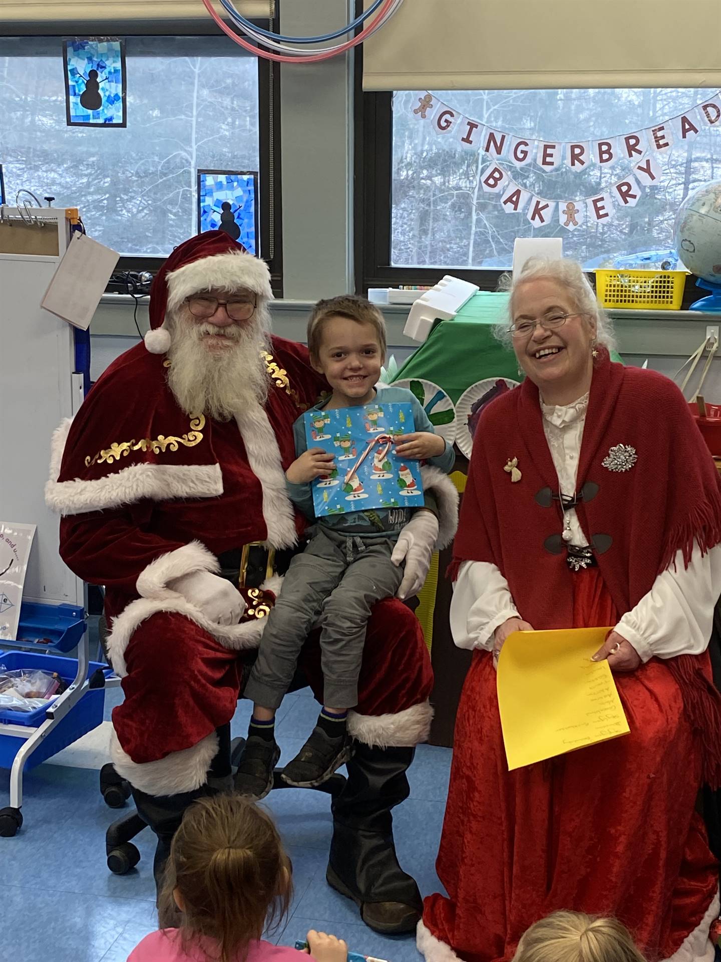 Santa and Mrs. Clause with student