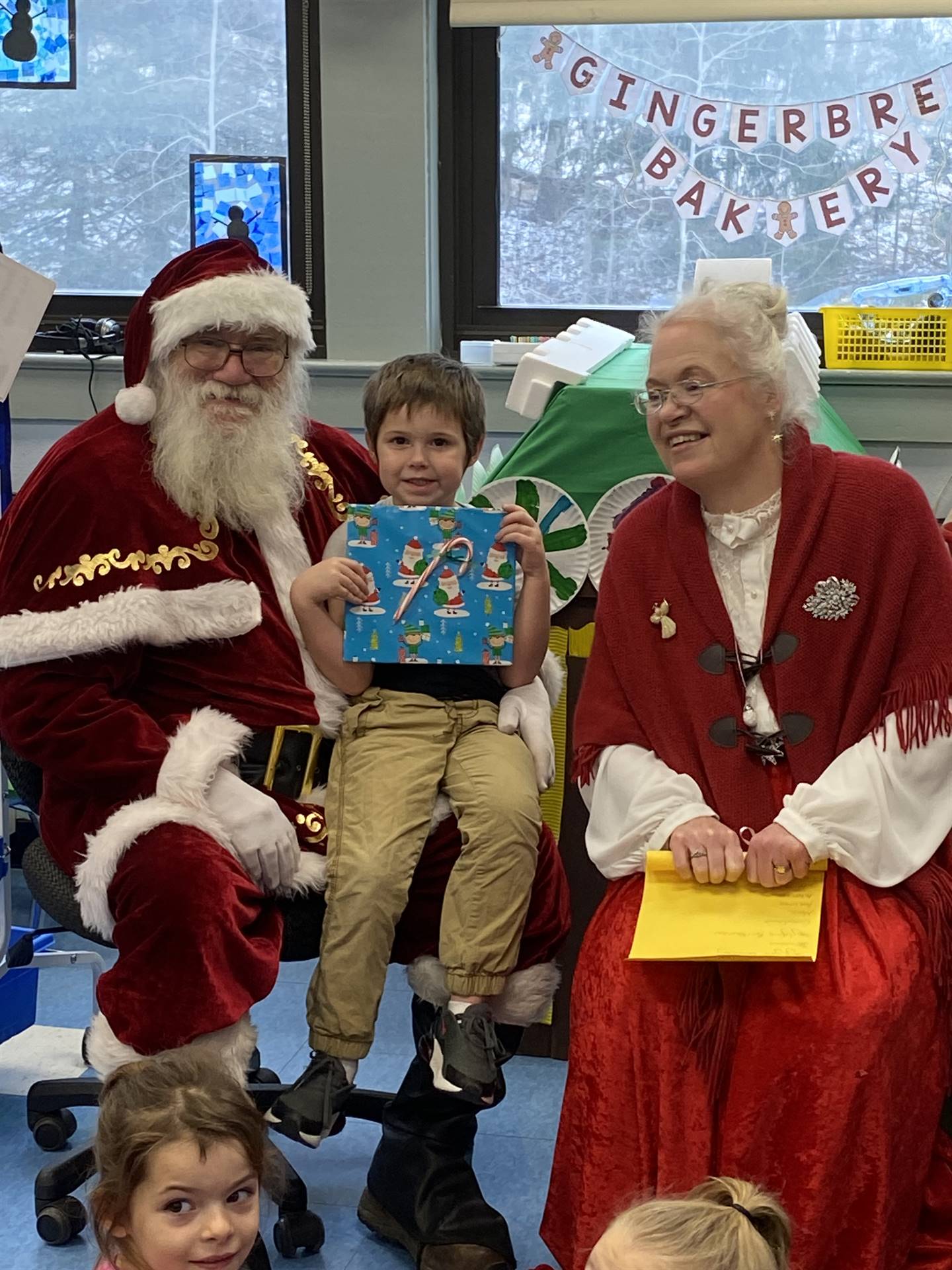 Santa and Mrs. Clause with student