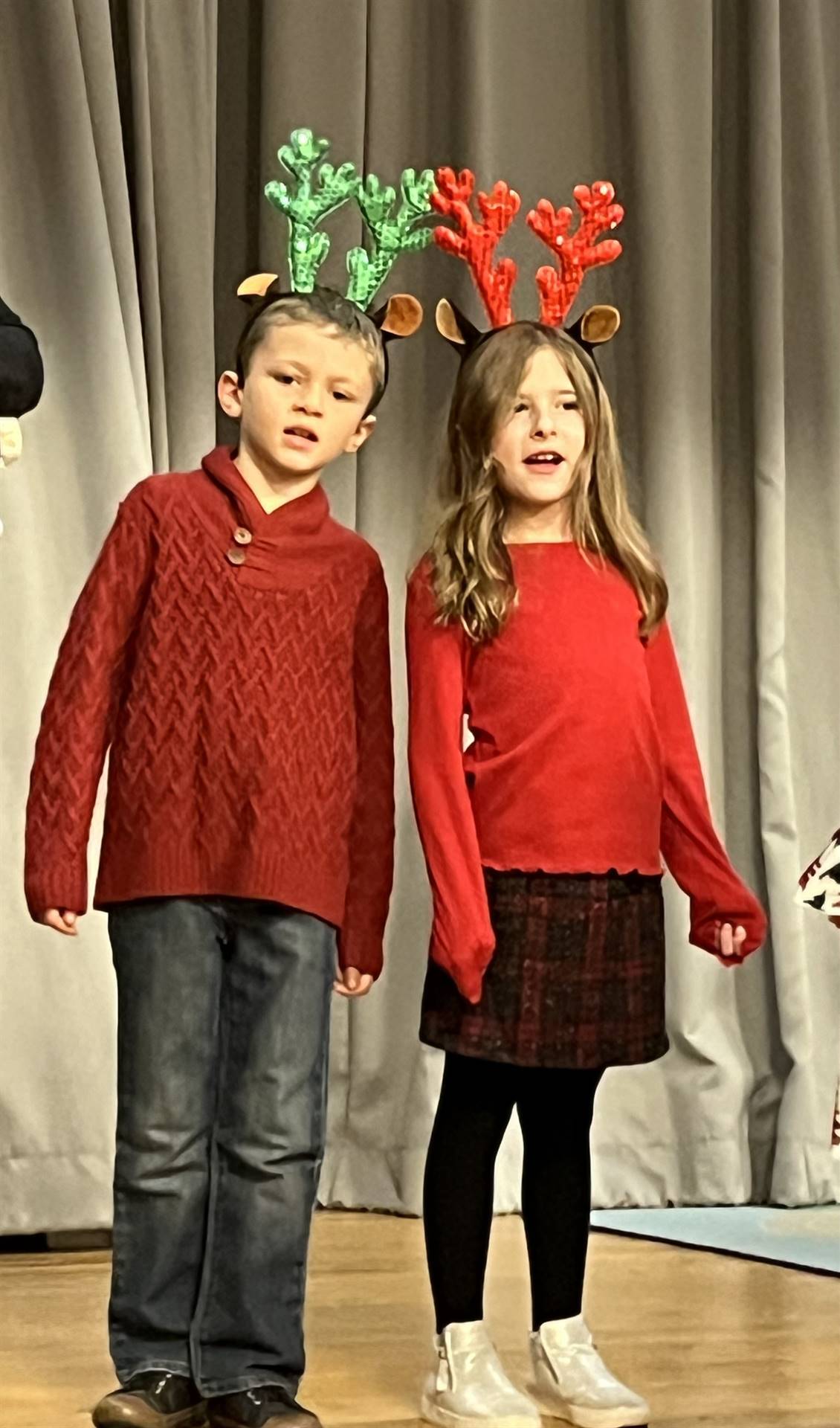 2 students with reindeer ears and red tops