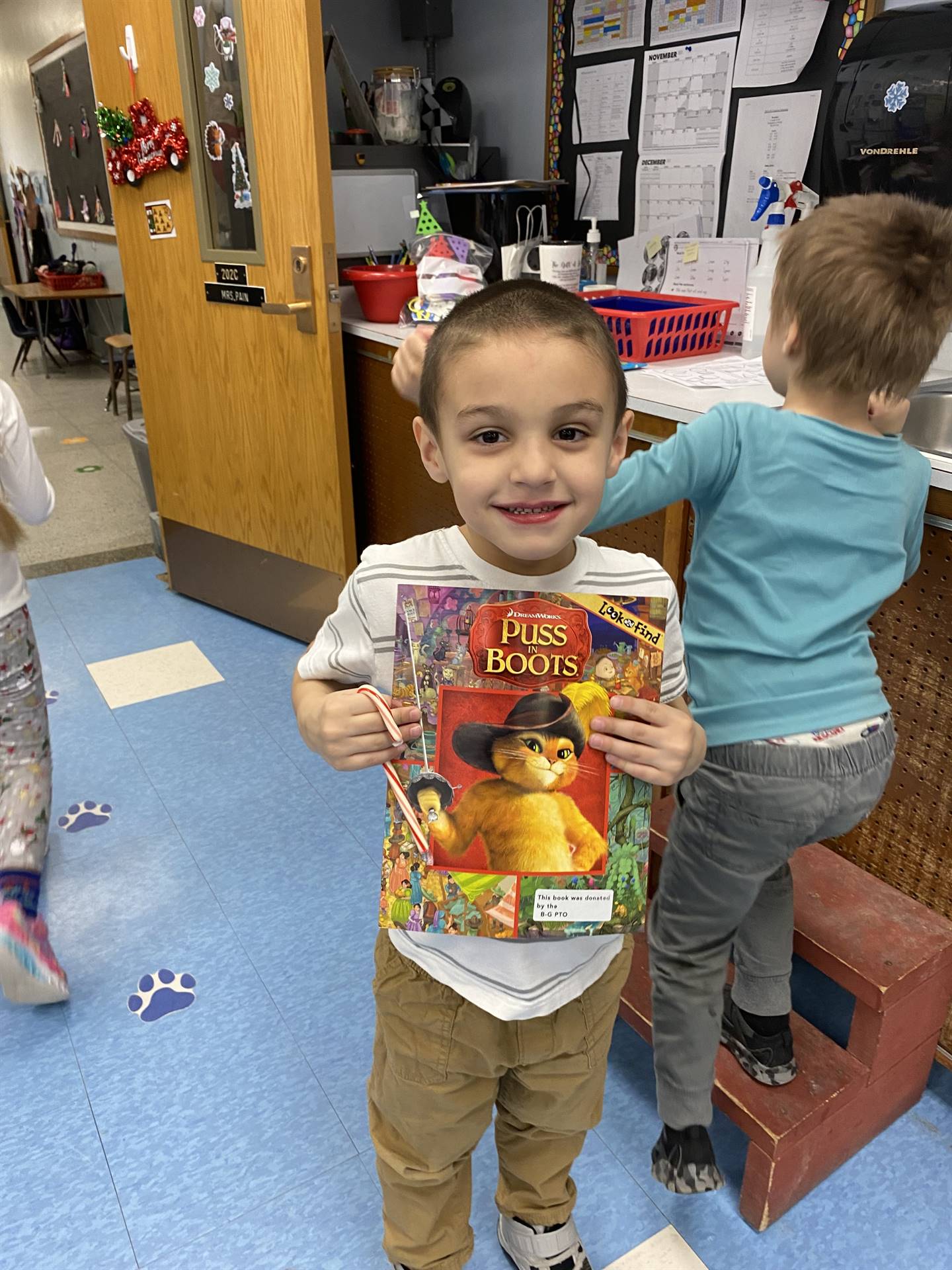 student holds up a book that was gifted by Santa Claus.