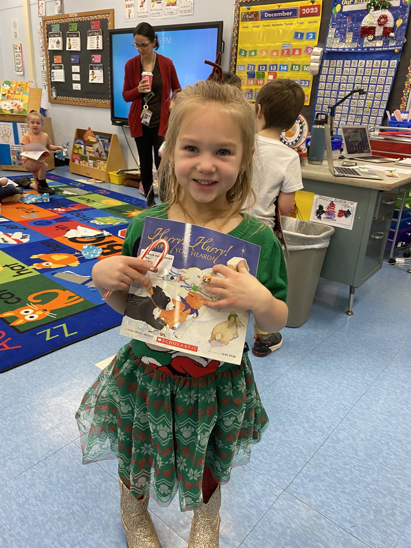 student holds up a book that was gifted by Santa Claus.