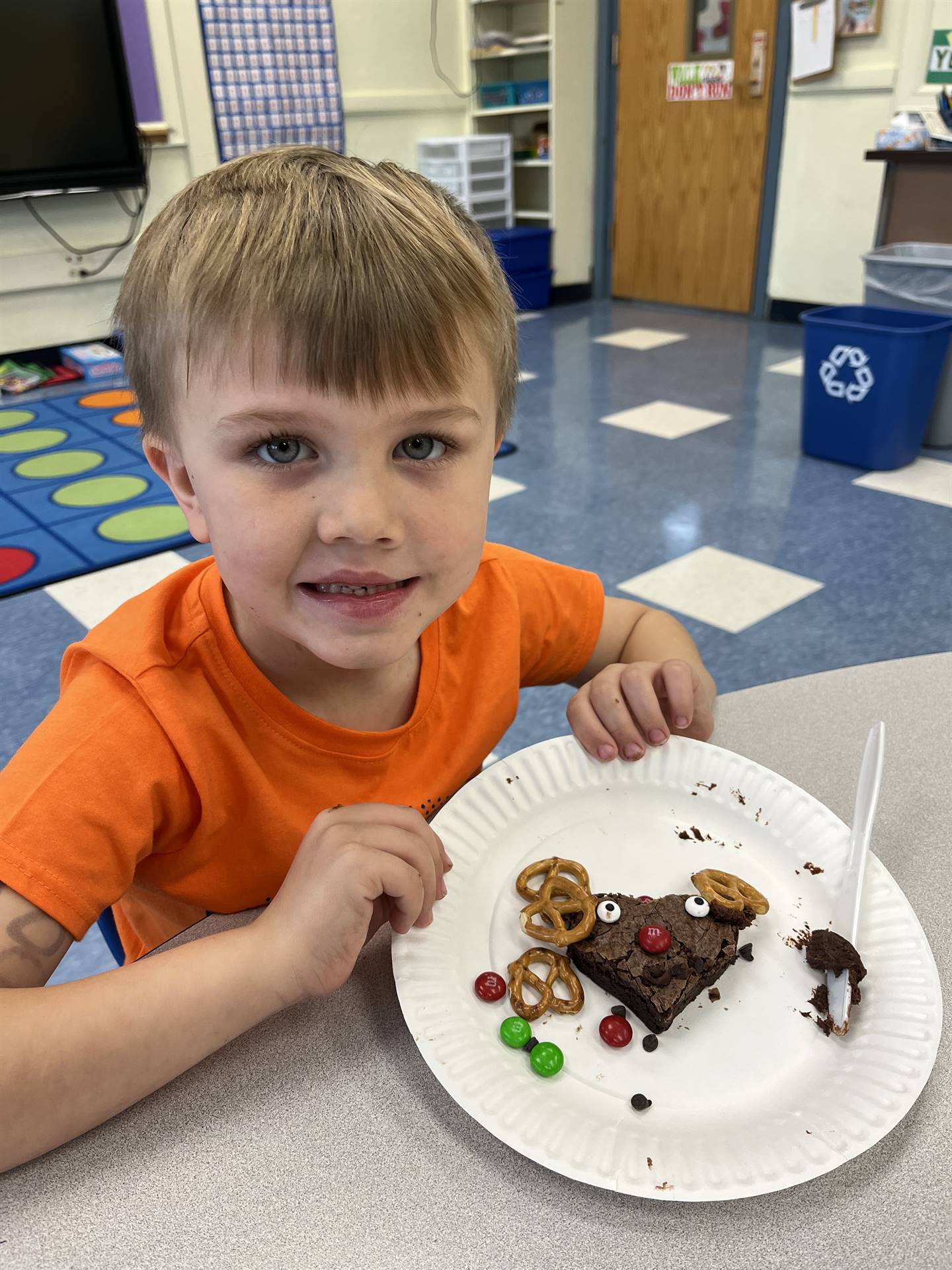 student shows reindeer on plate made out of food