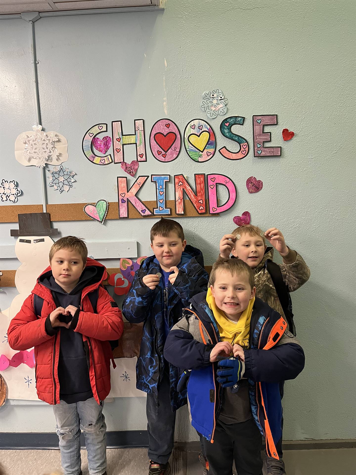kids making a heart sign with hands and a "choose Kind" background.