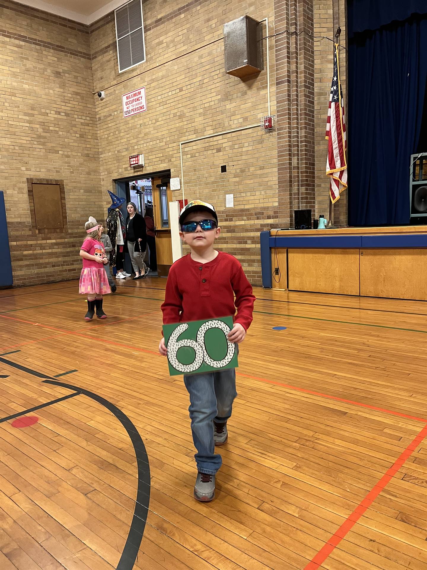 2 students dressed up as 100 yrs. old and holding sign 60.