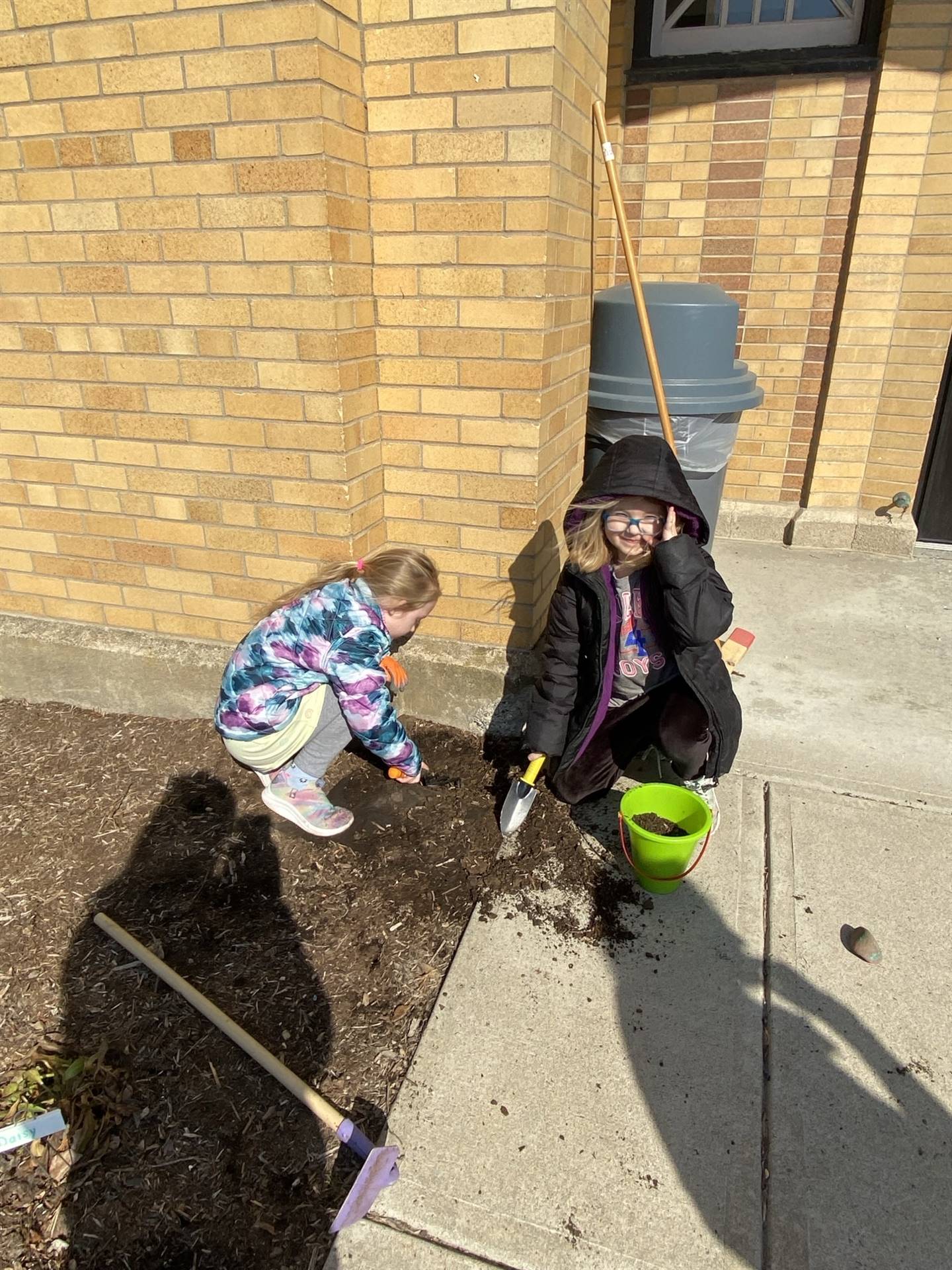 2 students digging in dirt.