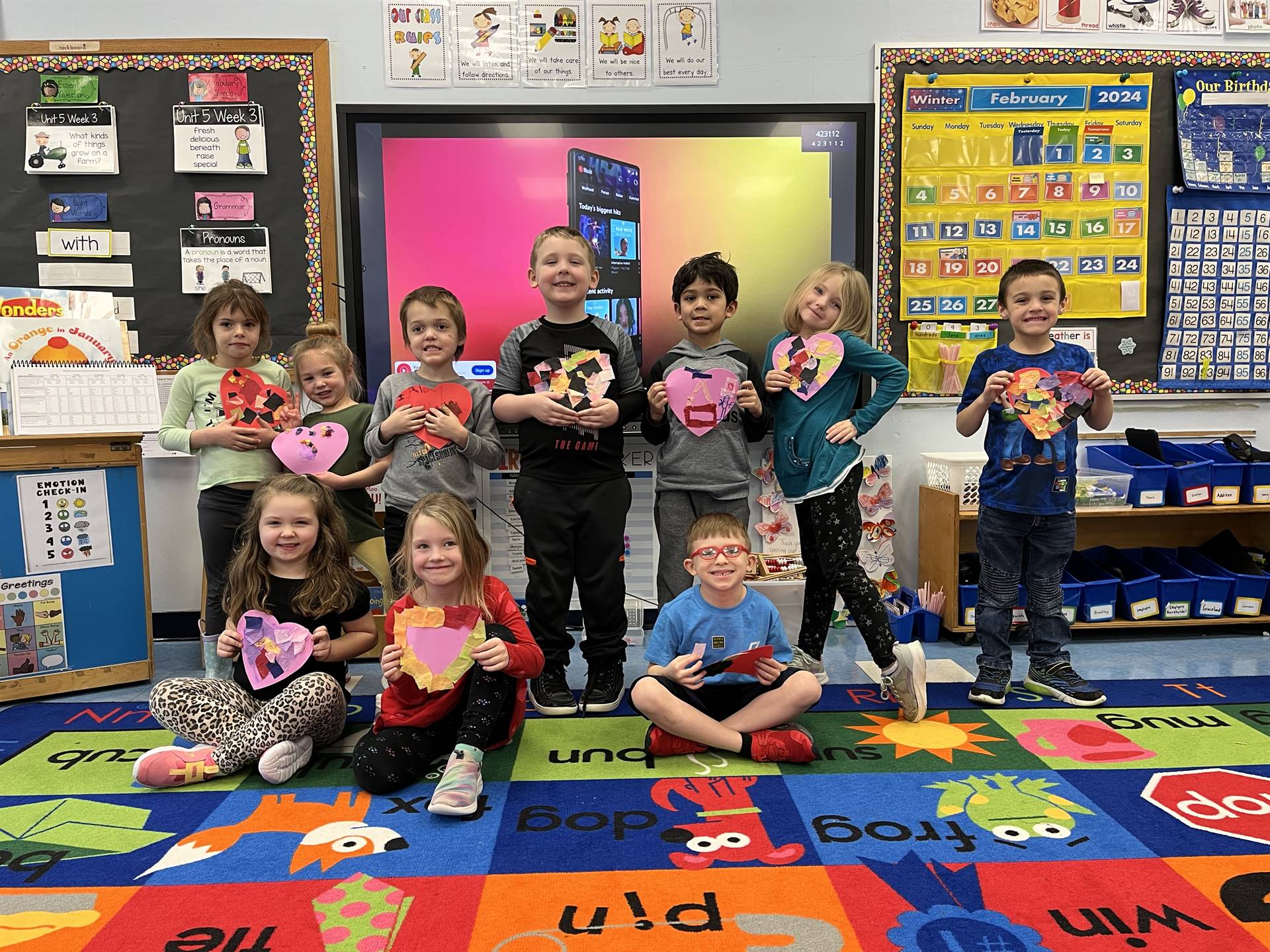 students hold a decorated heart.