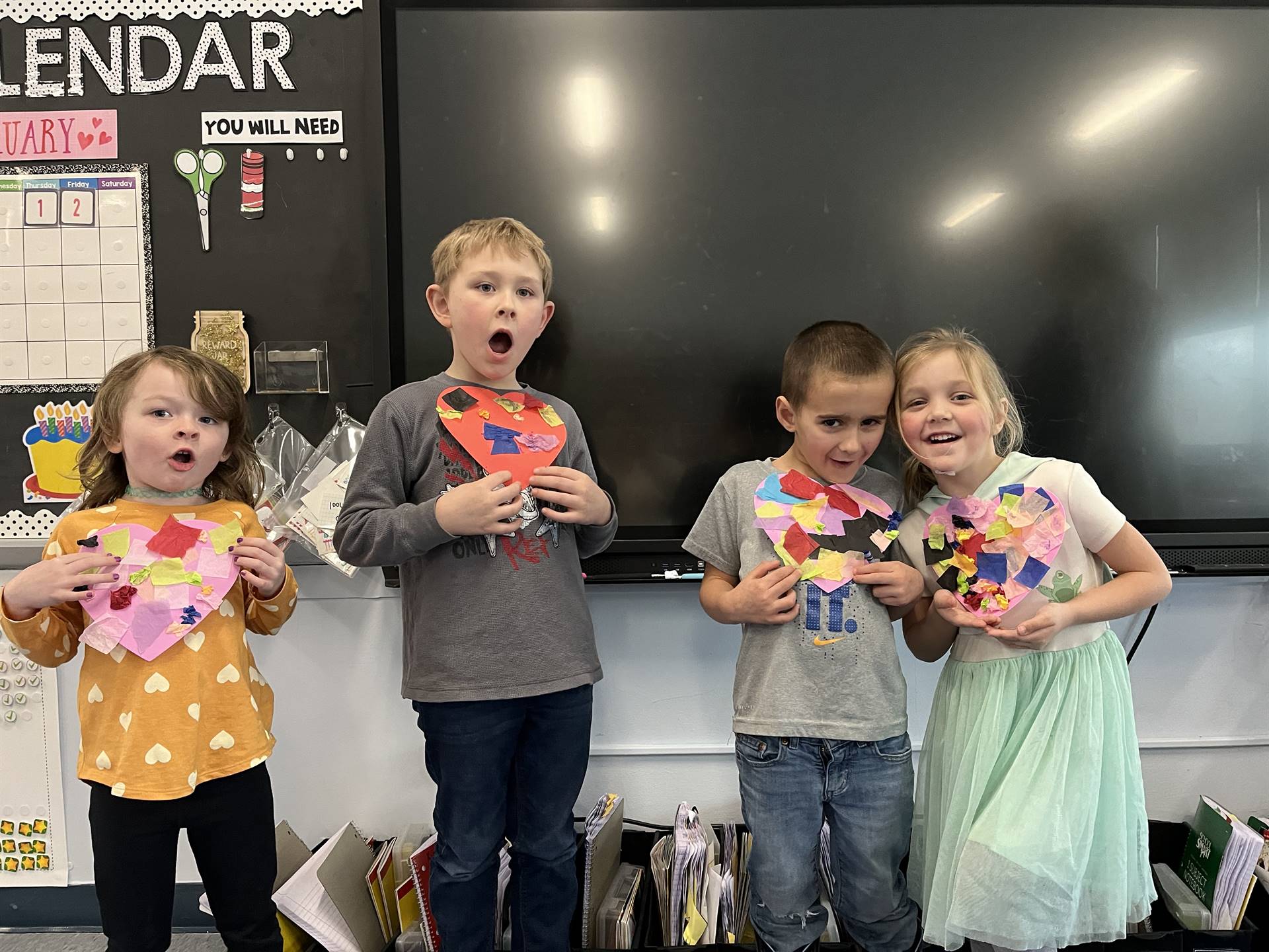 students hold a decorated heart.