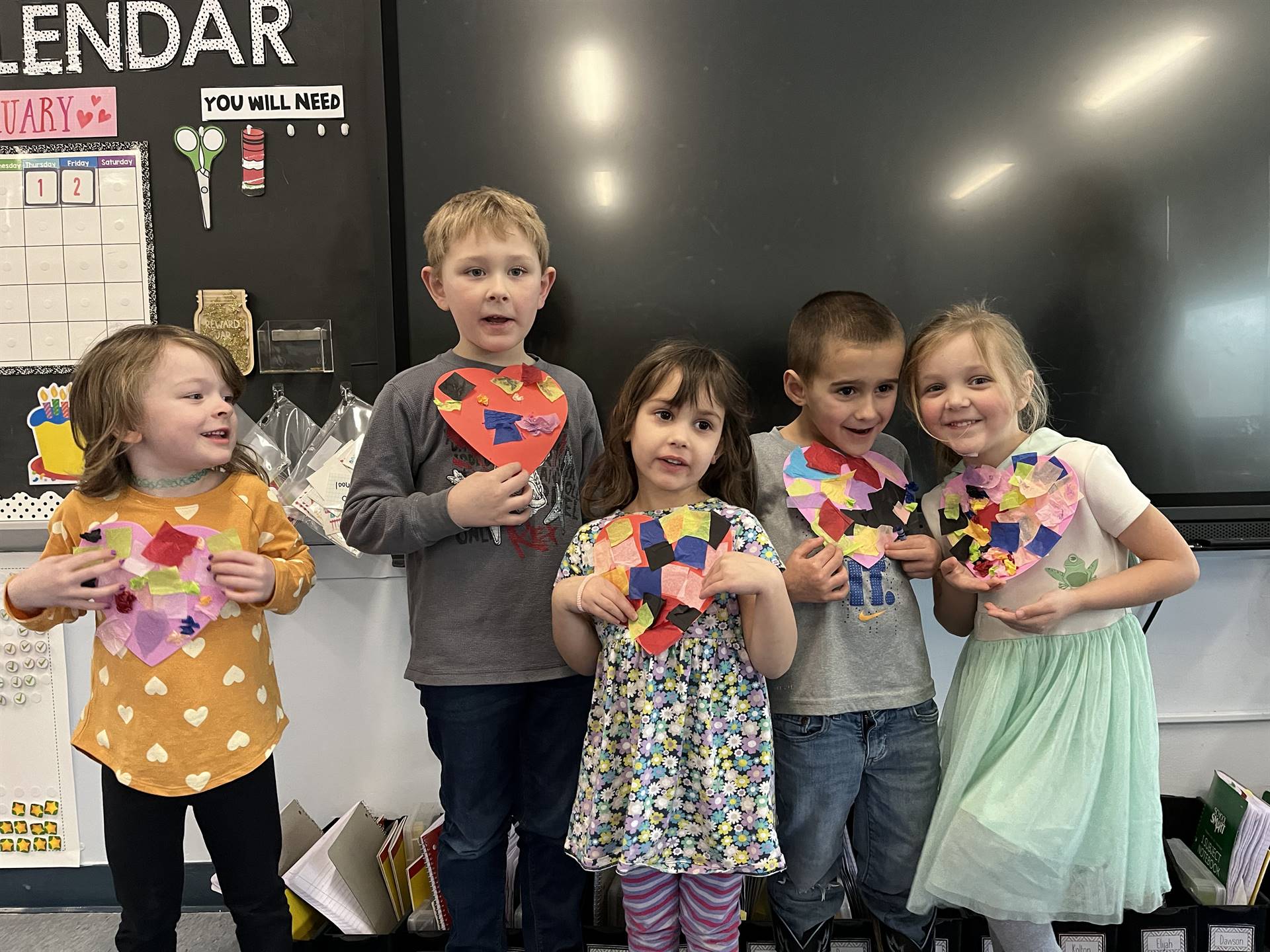 students hold a decorated heart.