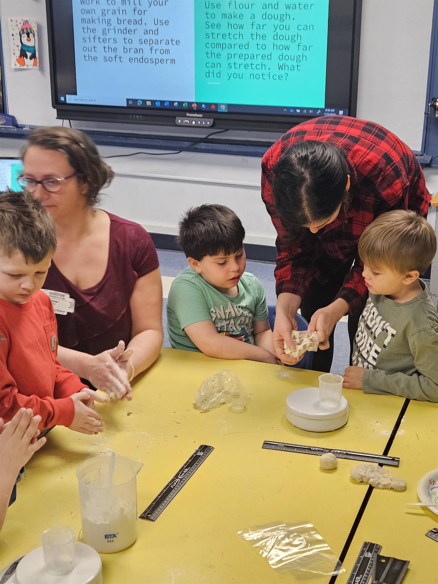 an adult works with student mixing flour and water